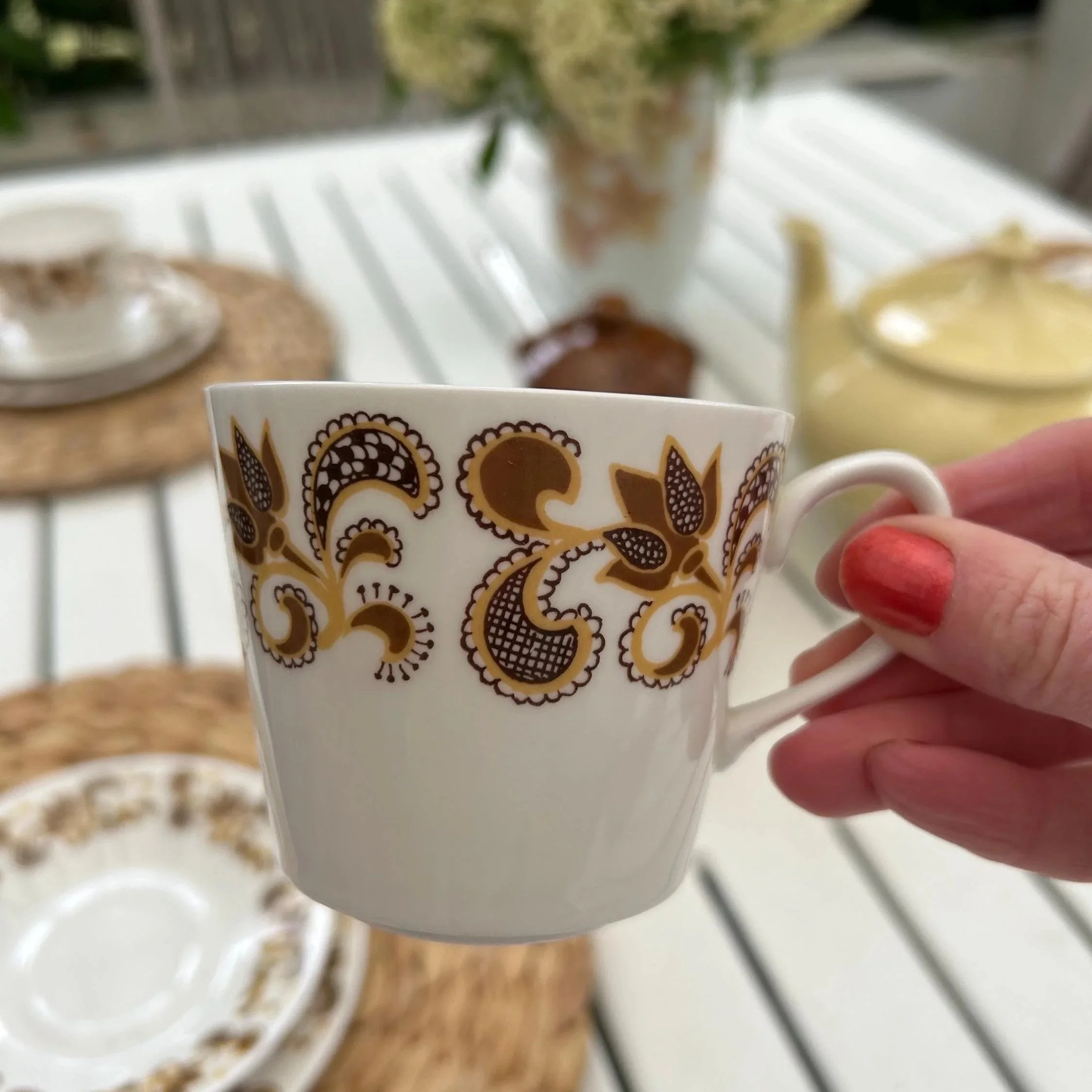 Close-up of cup design with rich brown and gold motif