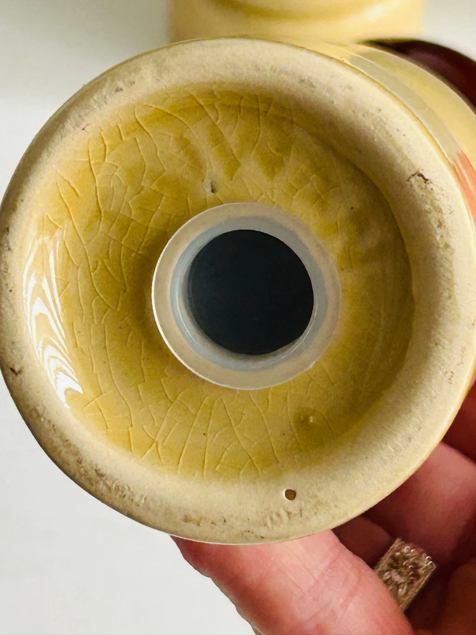 Close-up of the base underside showing age crazing in the glaze