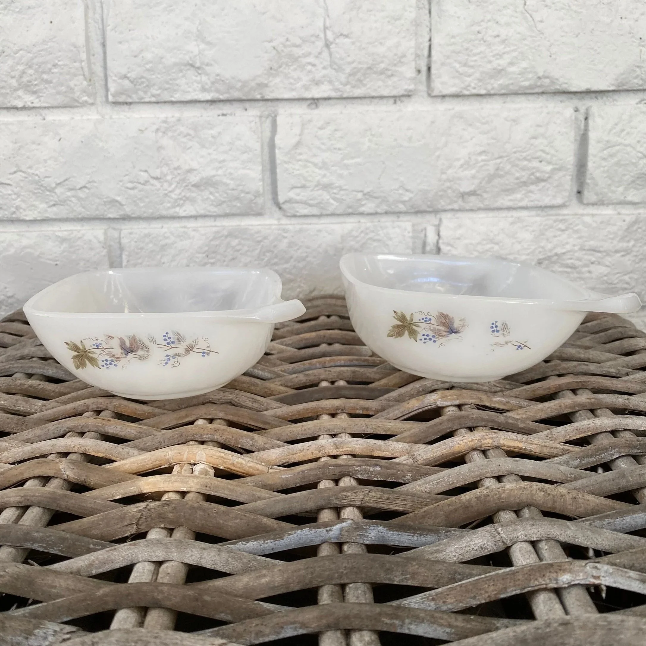 Pair of ramekins displayed on wicker surface with soft natural light