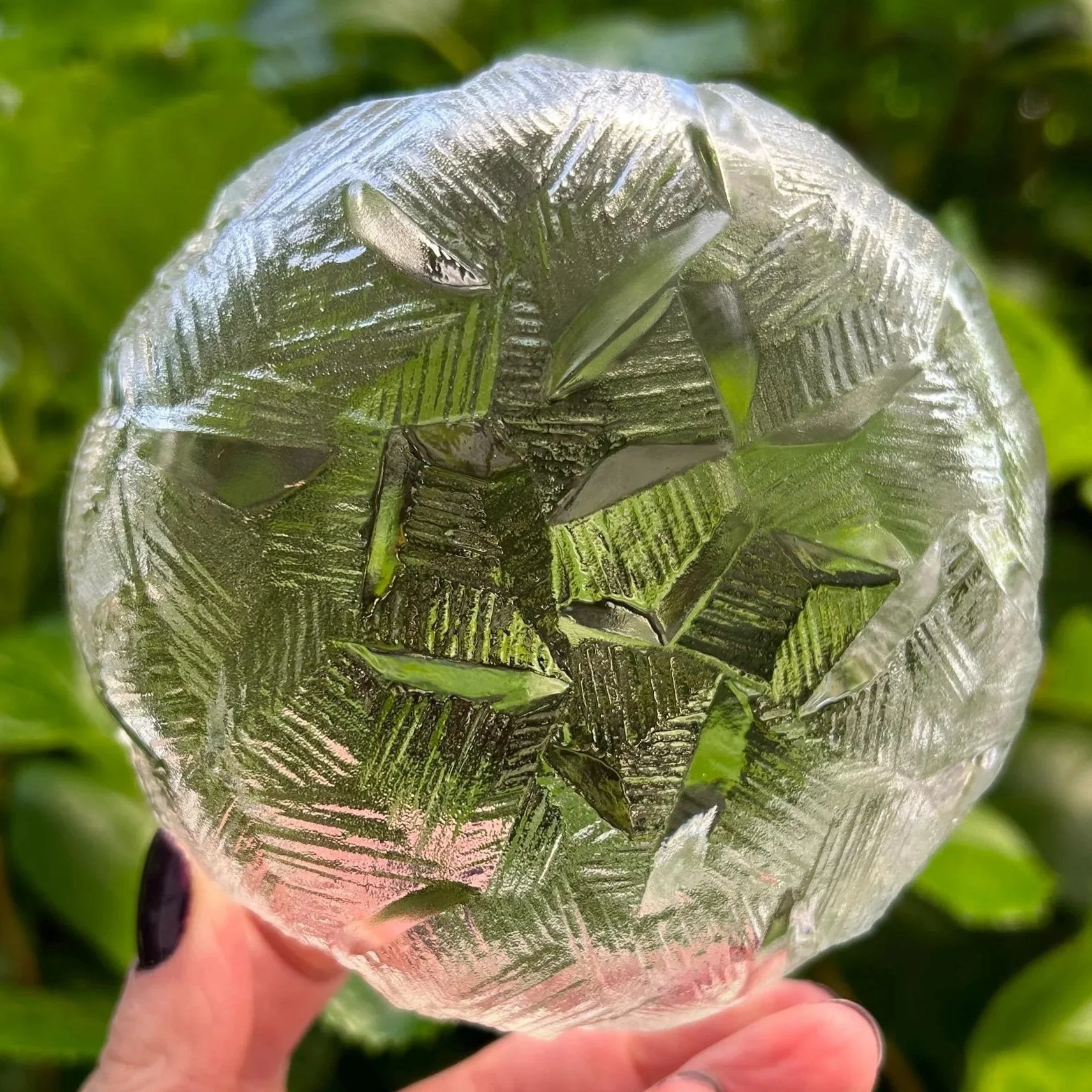 Underside of one bowl against greenery – base pattern clearly visible
