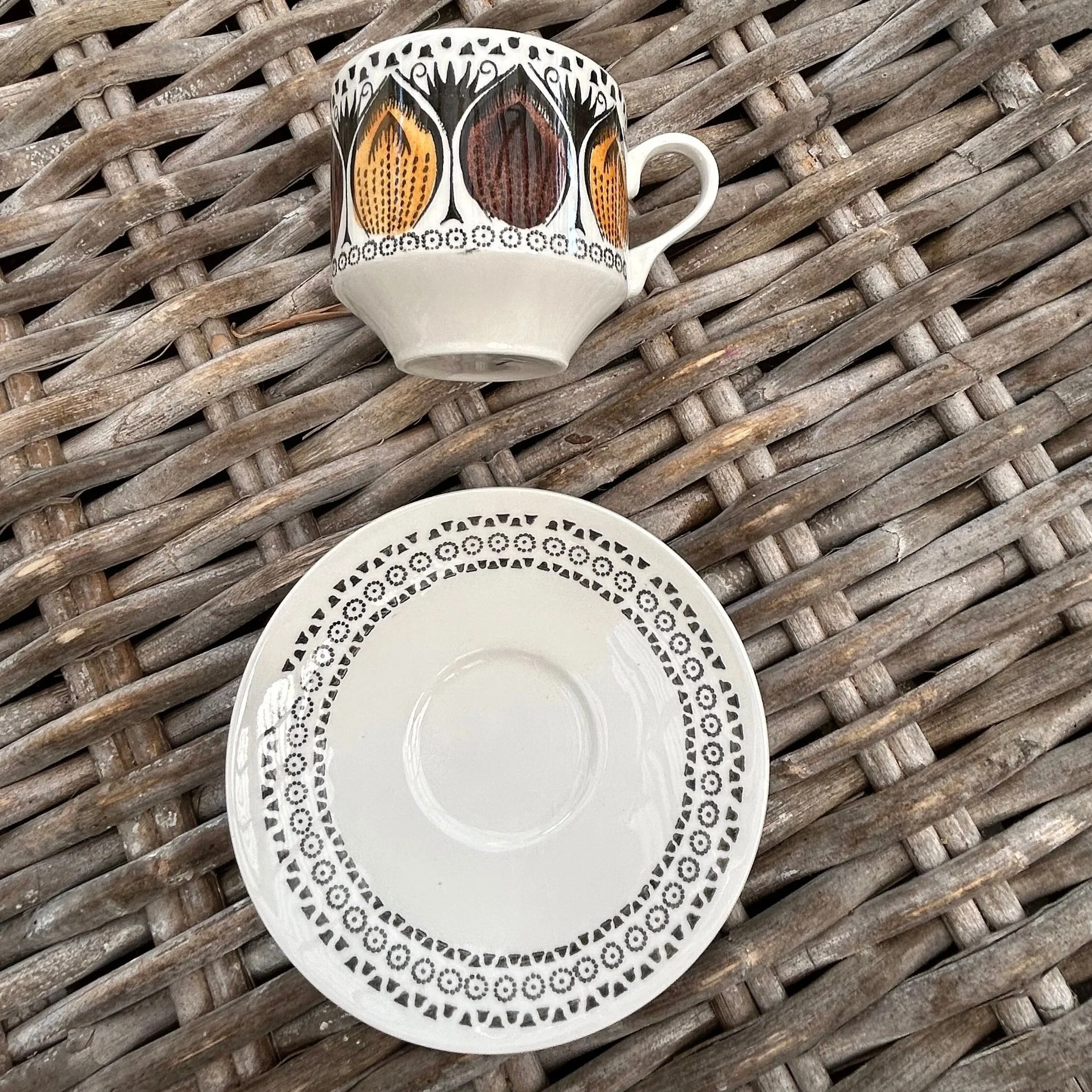 Single cup and saucer displayed on wicker surface