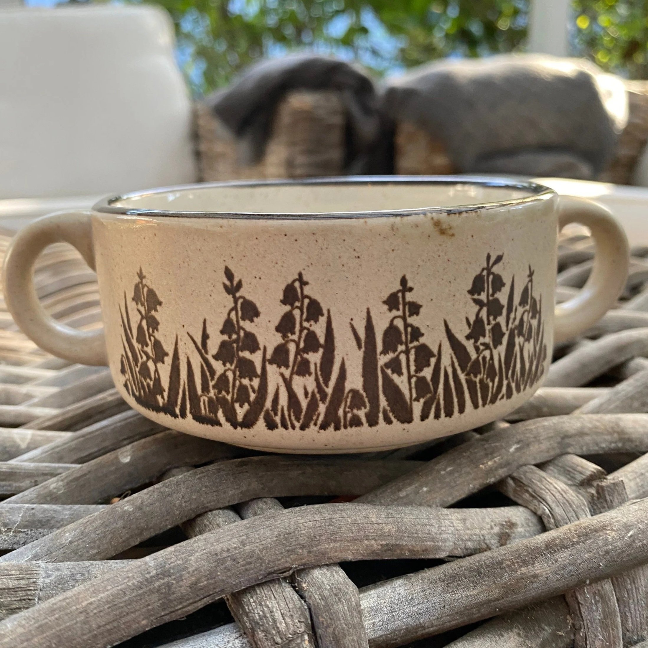 Angled view showing both handles and full floral motif wraparound