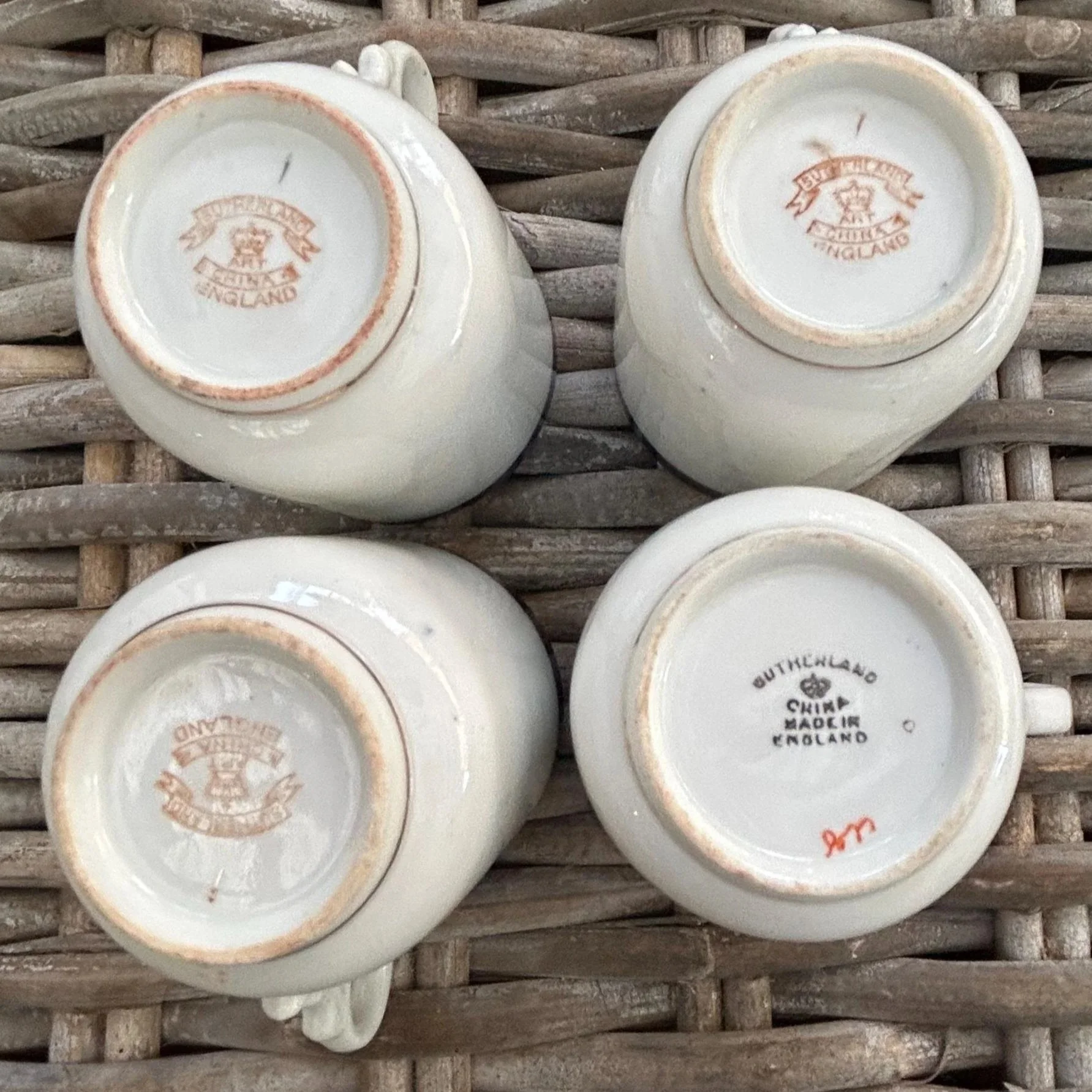 Underside view showing a variety of backstamps and base details