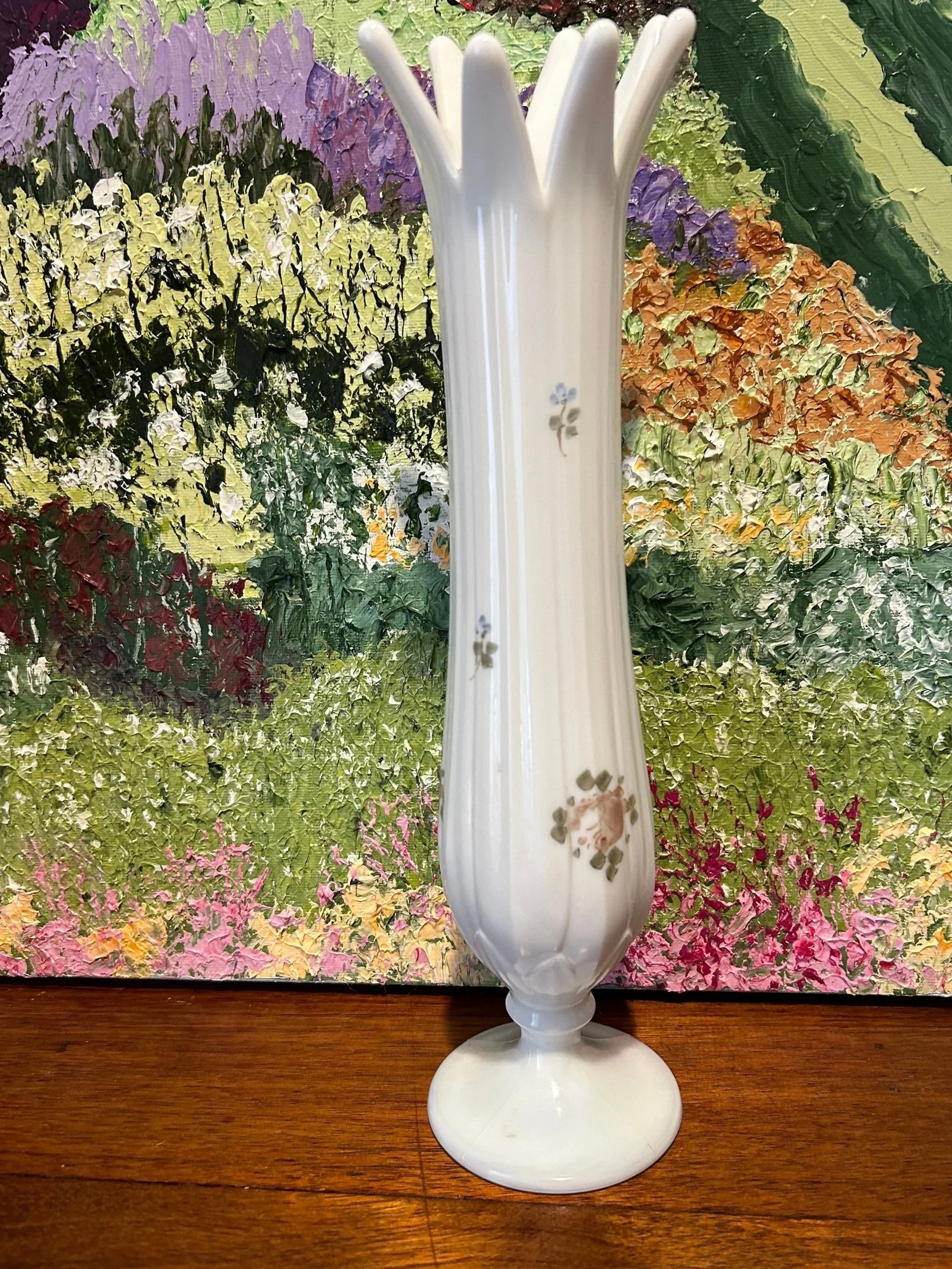 Full front view of vase with hand-painted florals against floral artwork background