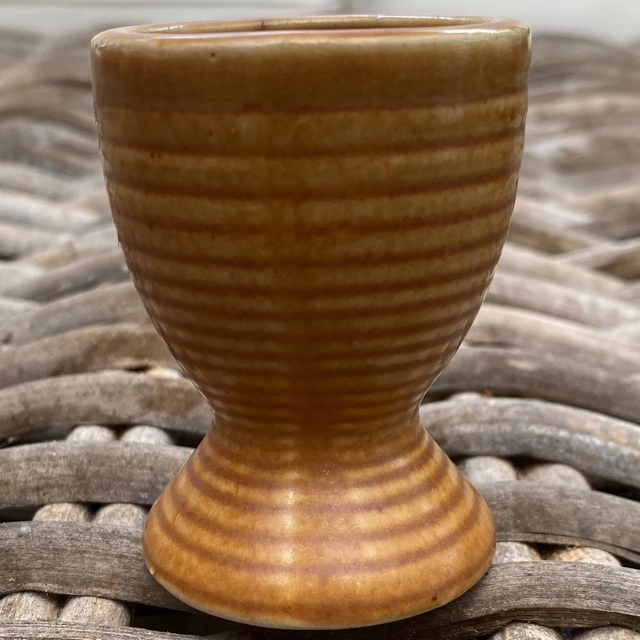 Single cup close-up showing ribbed surface and pedestal shape