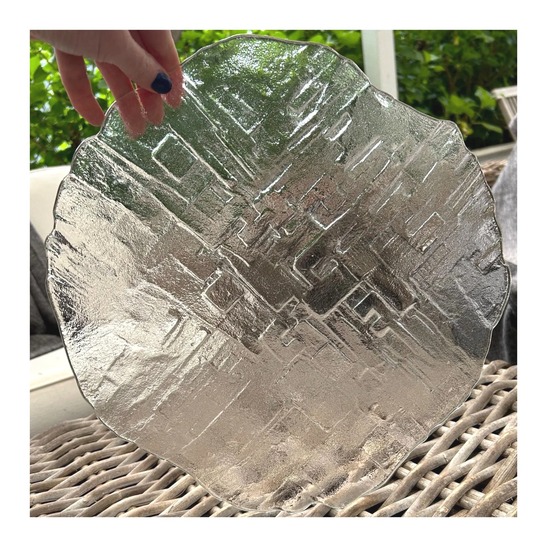 Hand holding Sklo Union ‘Mesto’ platter upright to show brutalist glass texture