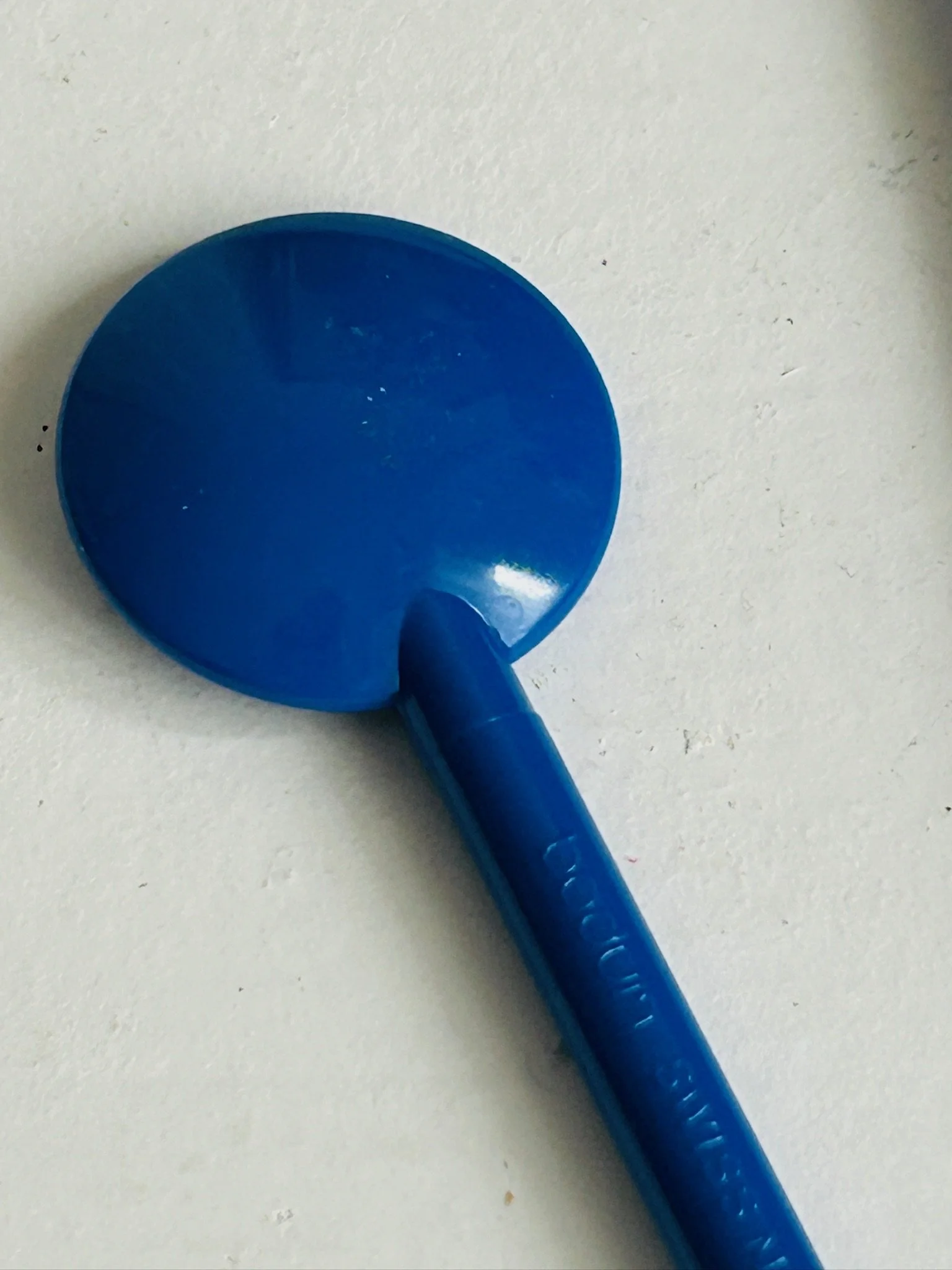 Close-up of the round spoon bowl and upper handle of a Bodum blue stir spoon