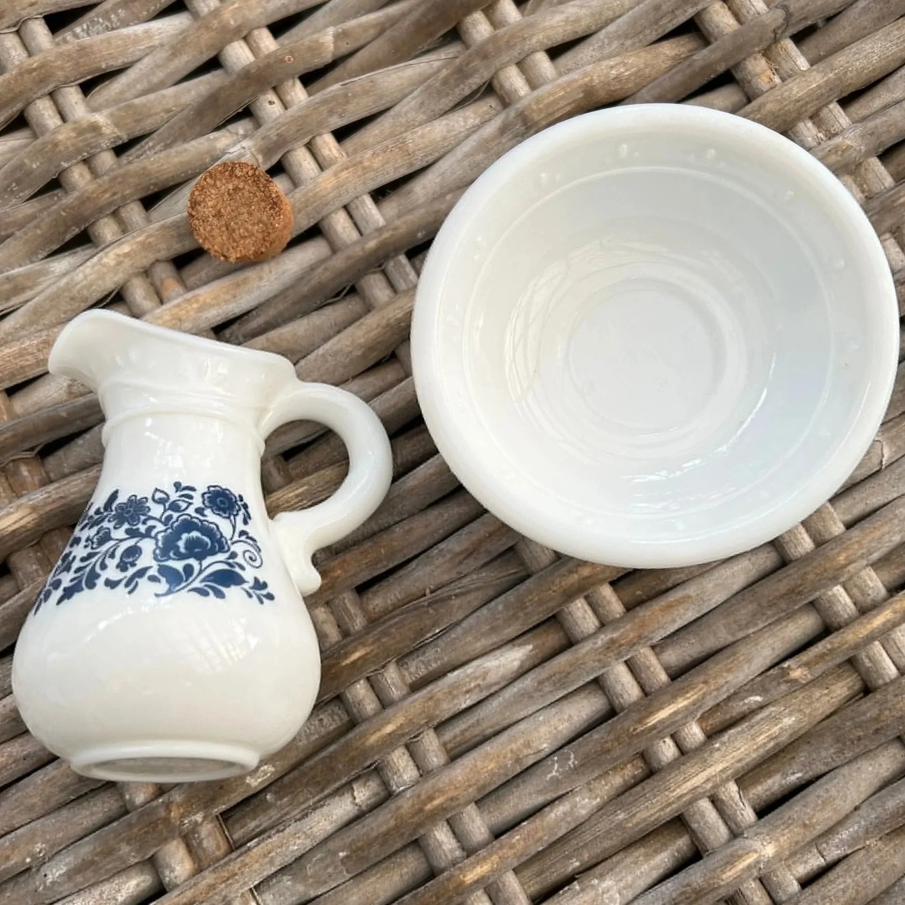 Top-down view of pitcher and bowl on wicker background