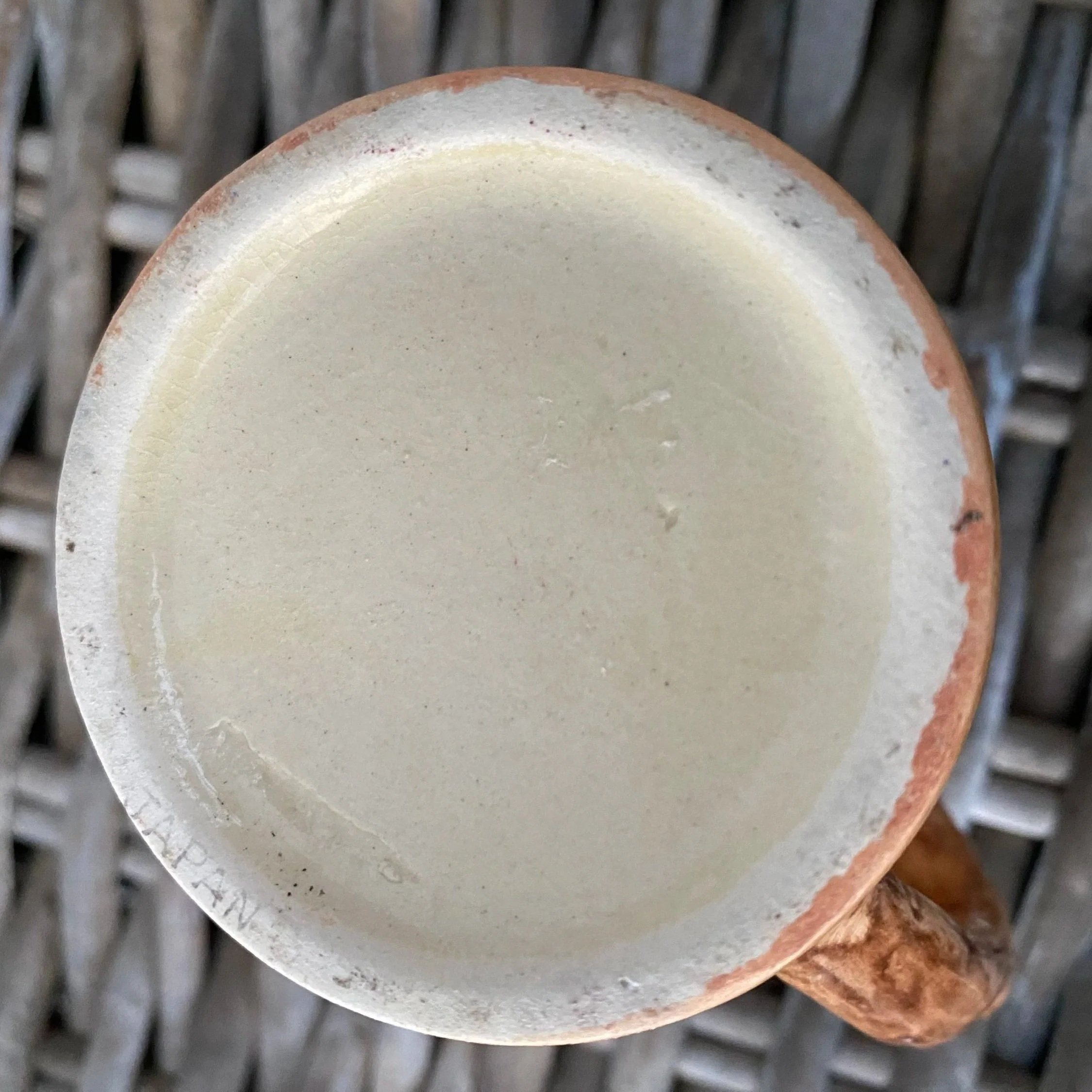 Base view of one tankard showing unglazed ceramic underside.