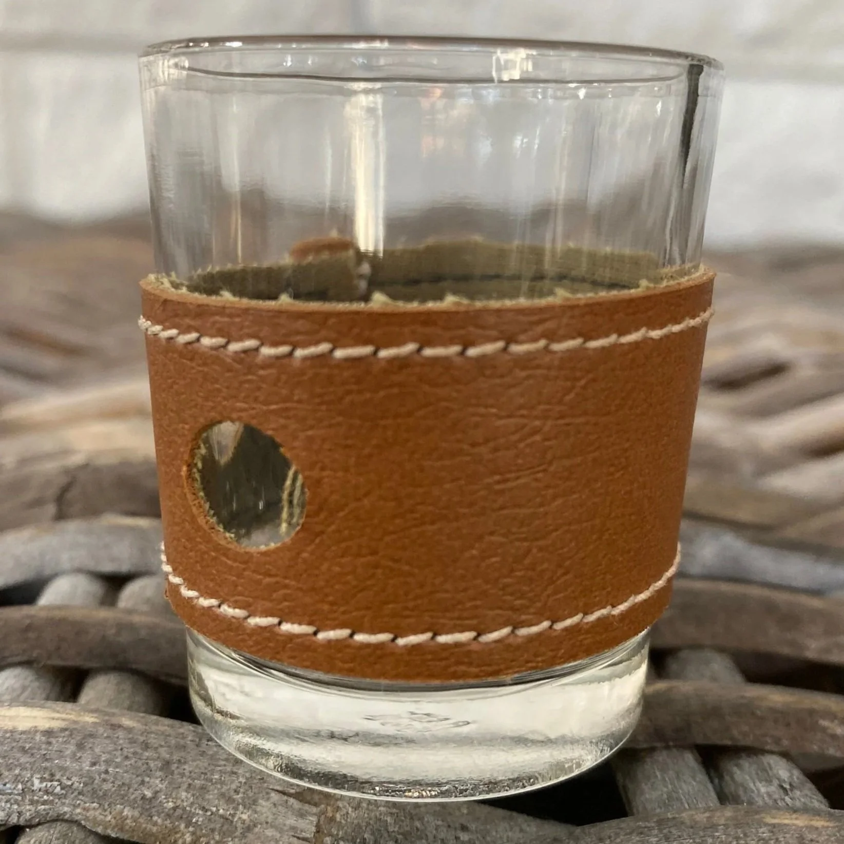 Brown leather sleeve with two punch-hole accents and detailed grain