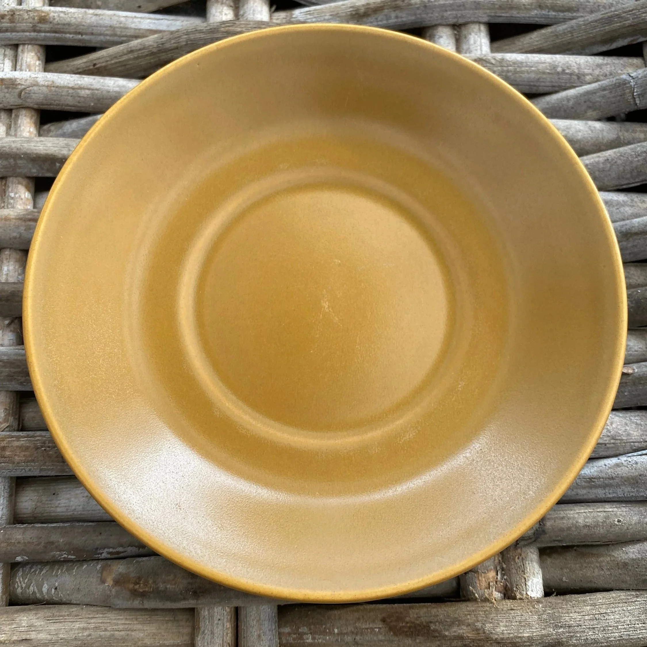 Golden brown saucer shown from top view