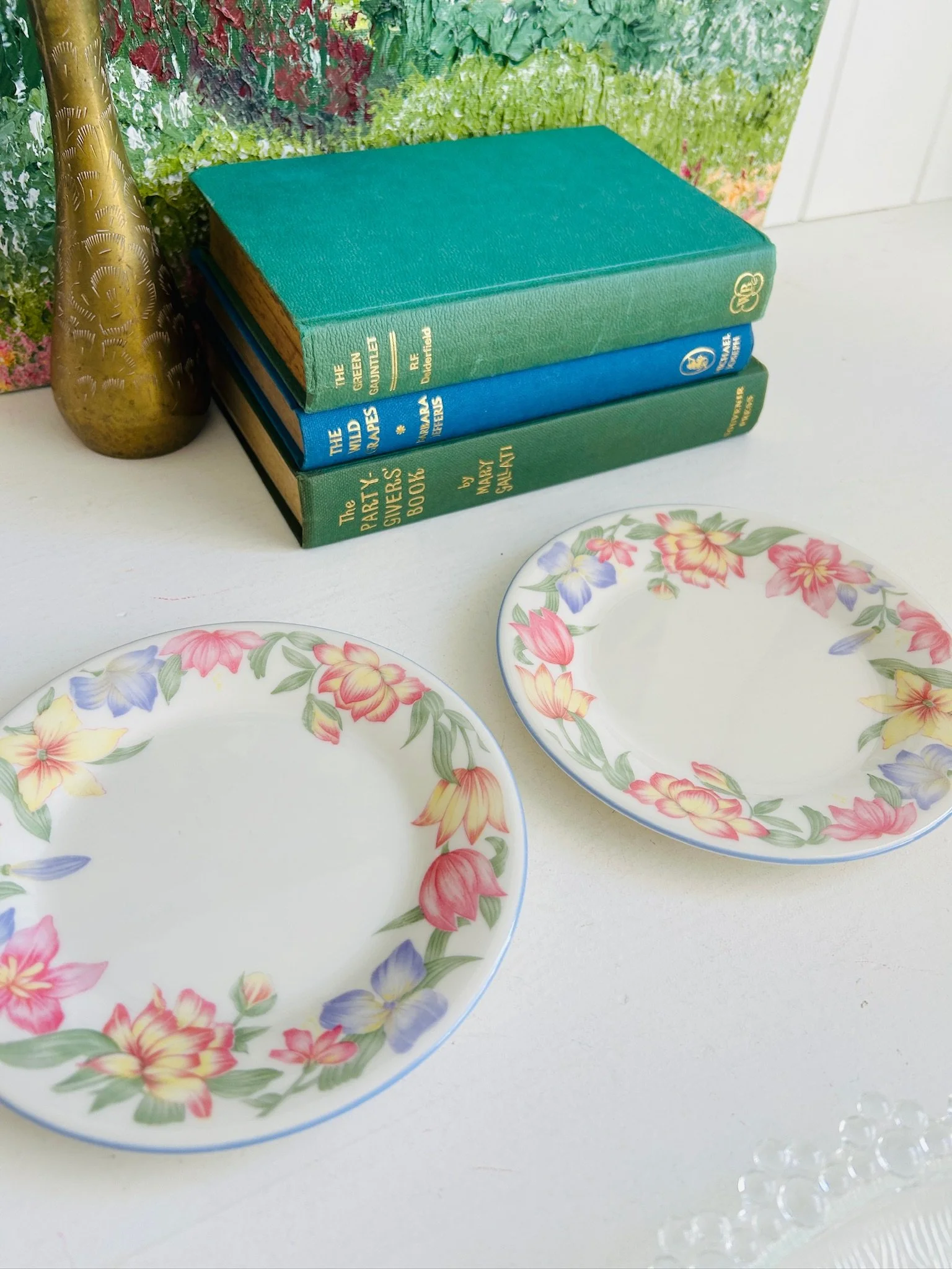 Two Royal Doulton Blooms side plates displayed together on a white surface, showing the pastel floral borders and fine china finish