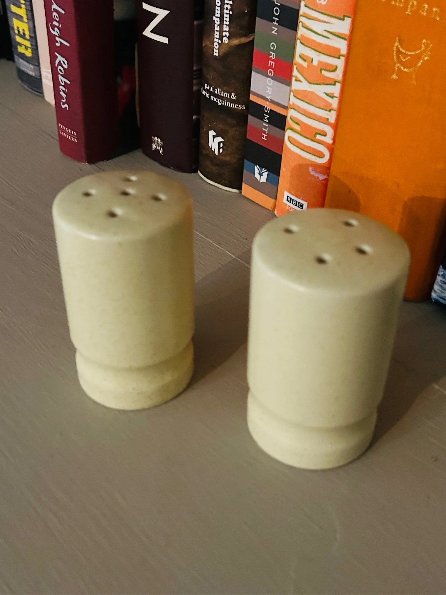 Front angled view of the shakers on a shelf, with one slightly forward to show the matching forms