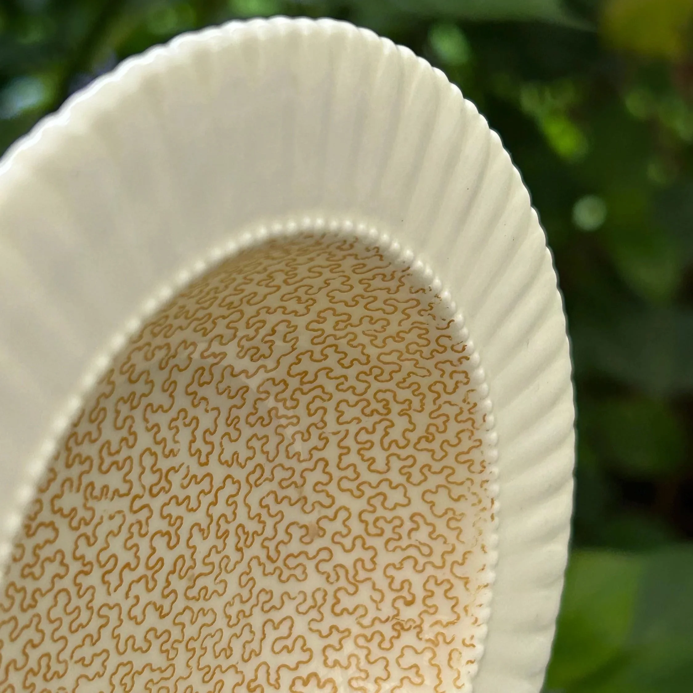 Close-up of golden pattern and textured ridged edge