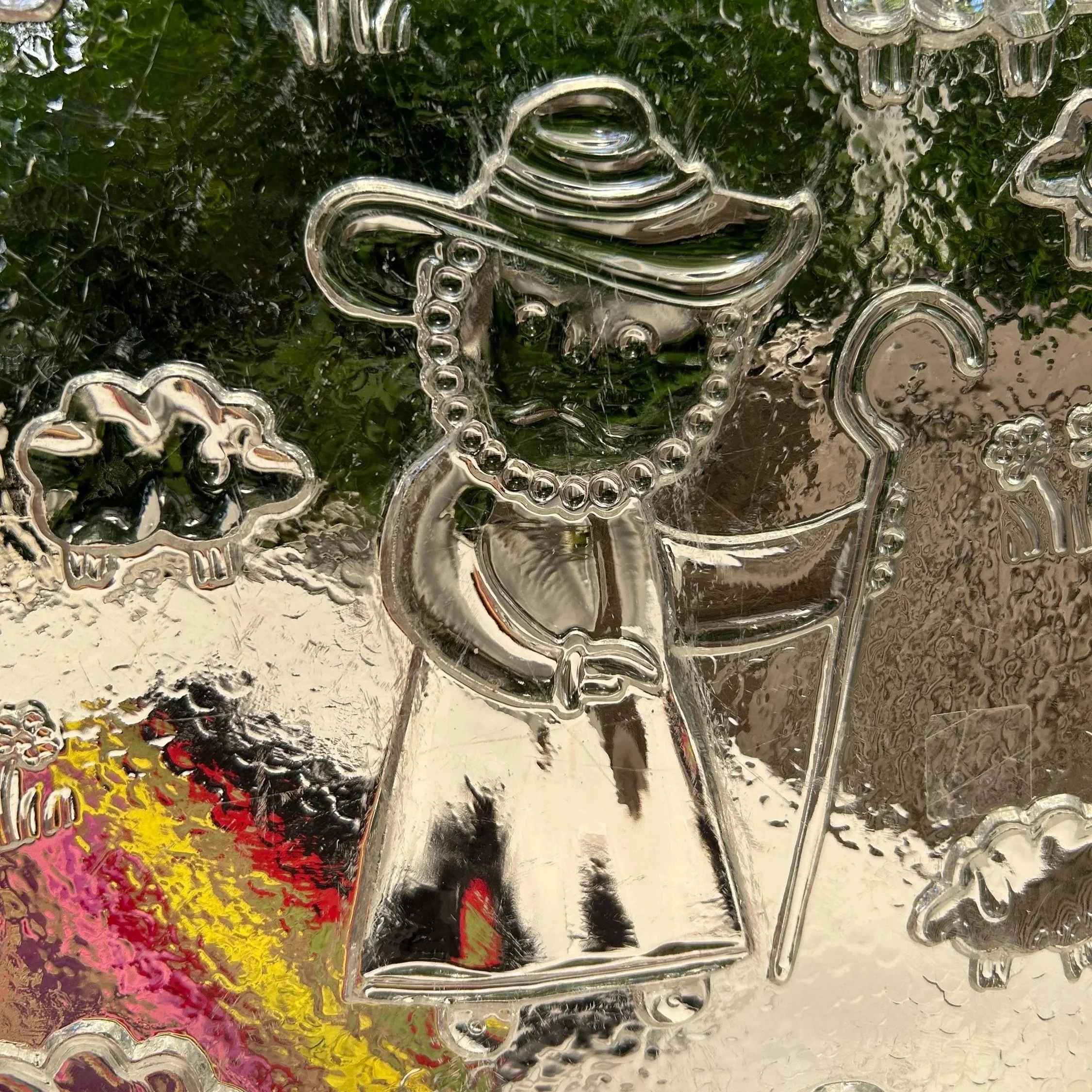 Close-up of shepherd figure embossed into the textured glass
