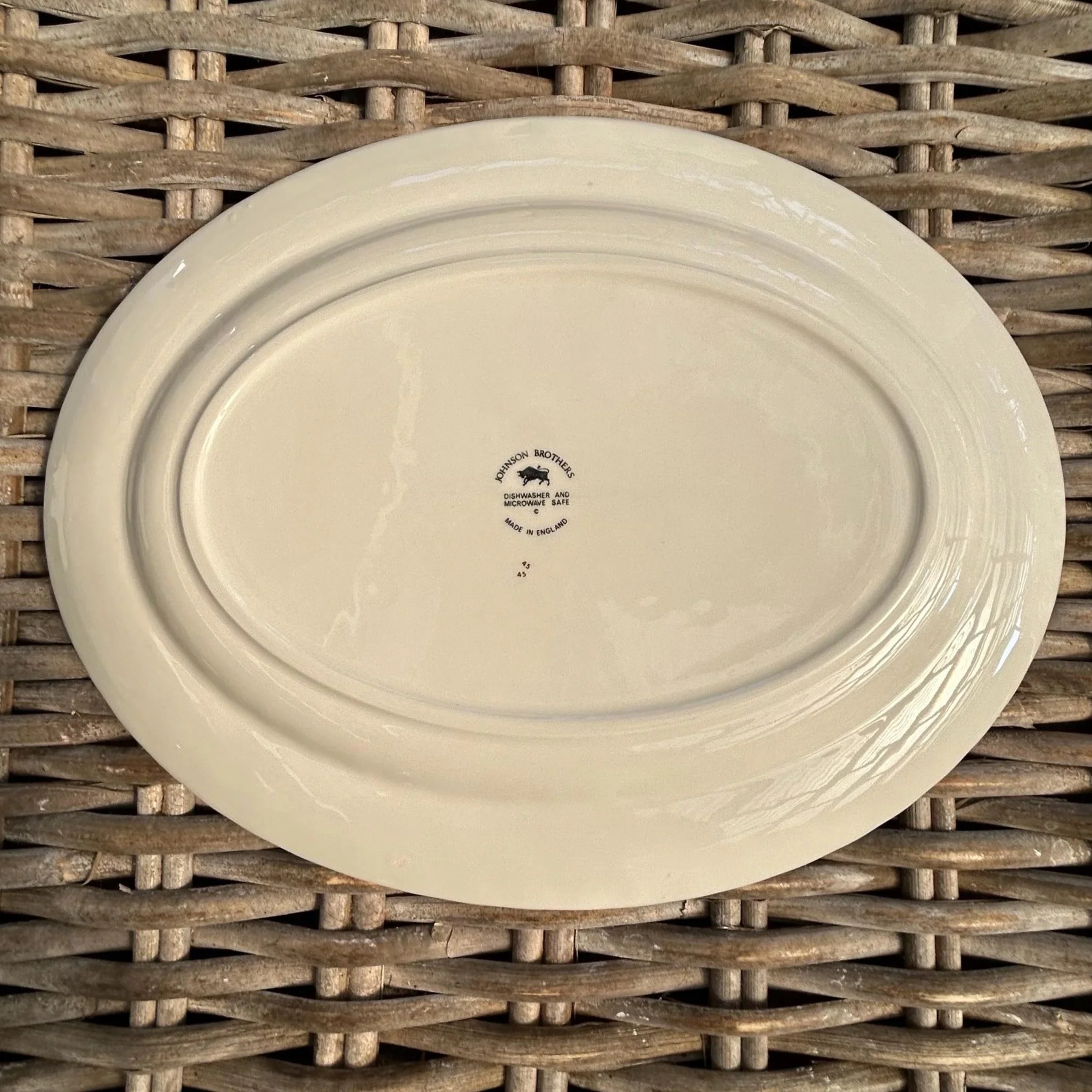 Underside of platter with clear backstamp and ivory glaze