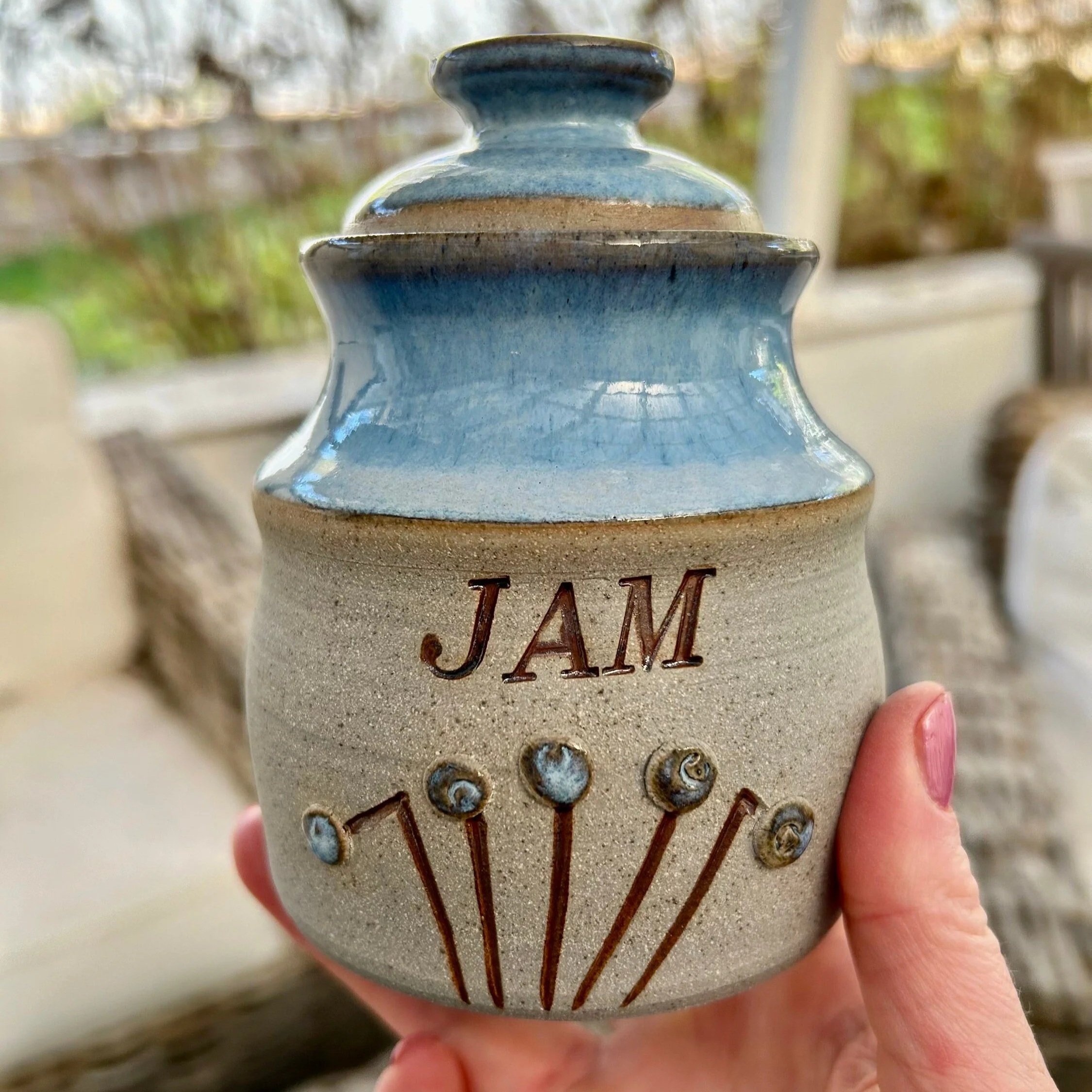 Full view of handmade pottery jam pot showing "JAM" inscription and full lid