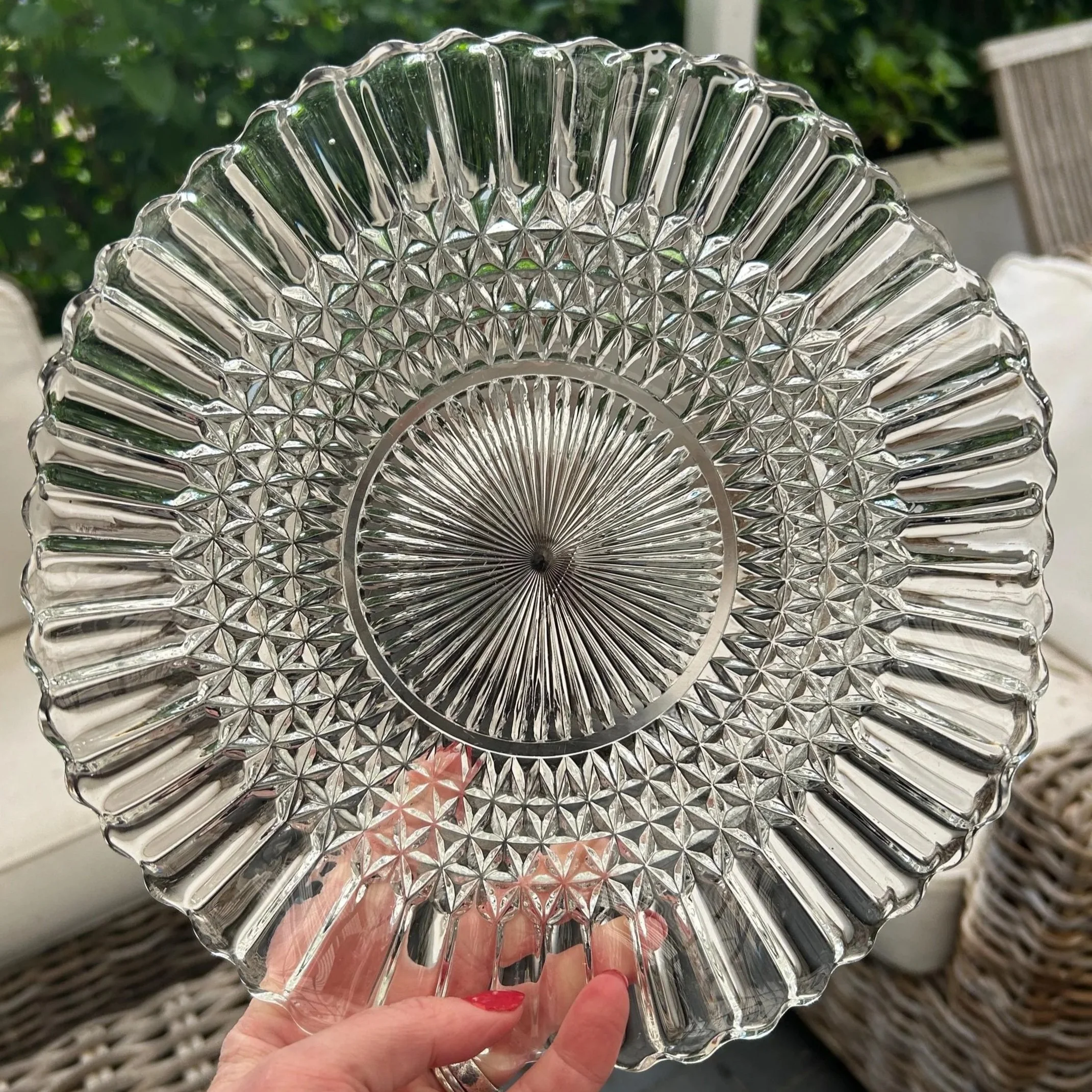 Overhead view of the crimped starburst glass plate held by hand