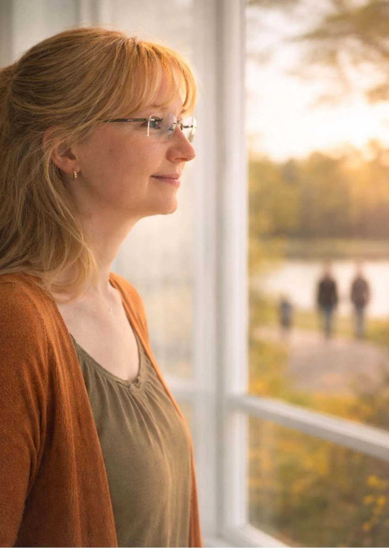 Eine blonde Frau die entspannt aus dem Fenster schaut.