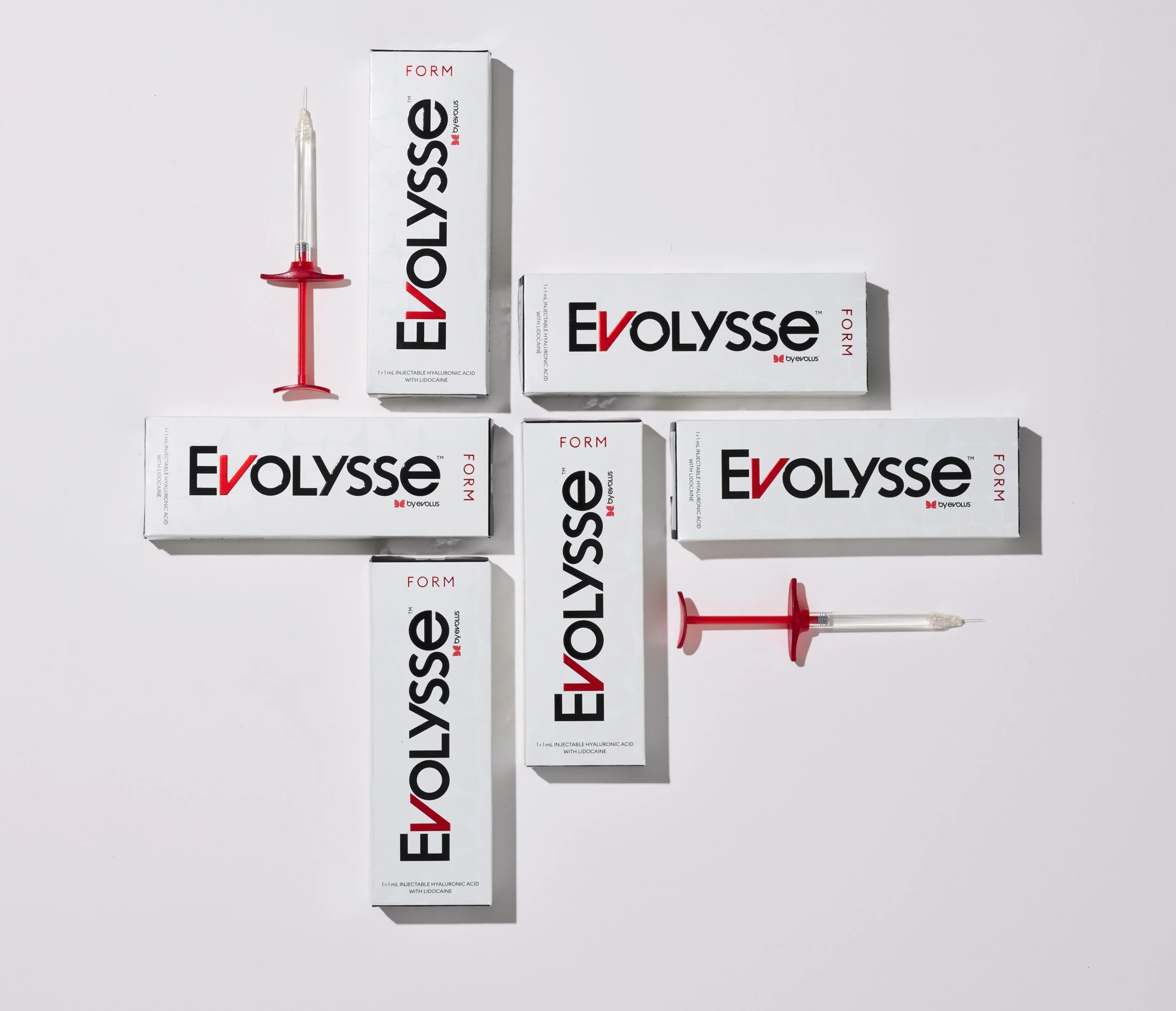 Boxes of Evolyss Form dermal filler with syringes on a white background, arranged in a cross pattern.