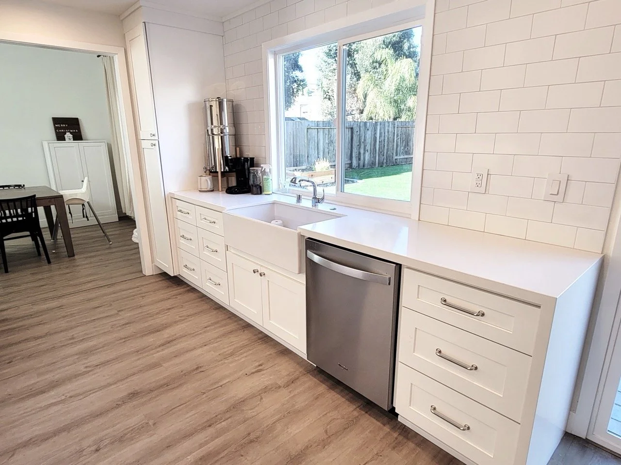Remodeledkitchencounters_whitecounters_whitewalltiles.jpeg