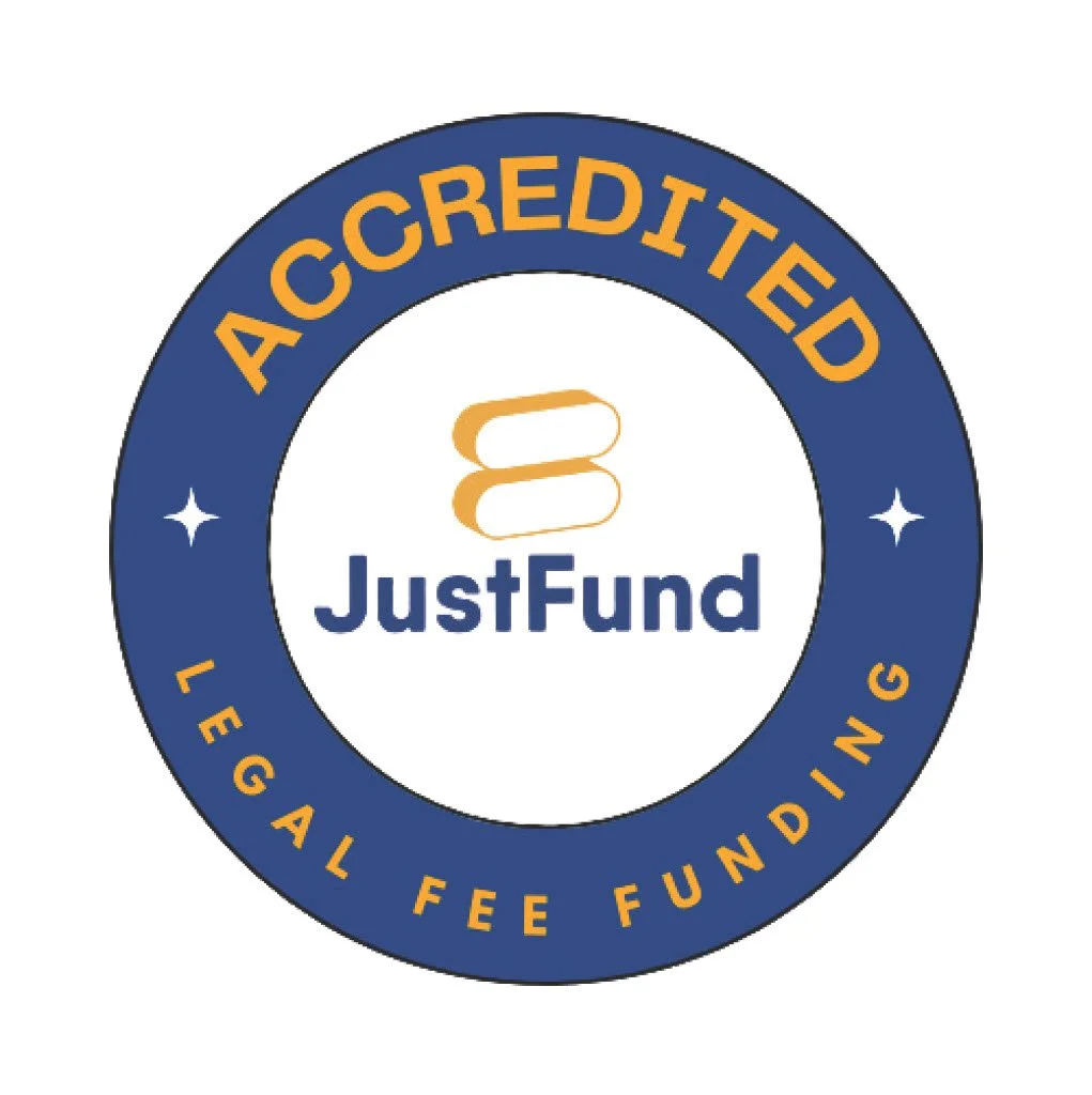 A circular badge with a blue outer ring and a white inner circle. The outer ring has the words 'APPROVED' at the top and 'LEGAL FEE FUNDING' at the bottom in yellow text. The inner circle features the JustFund logo, which includes a stylized gold or yellow stacked shapes and the words 'JustFund' in blue.