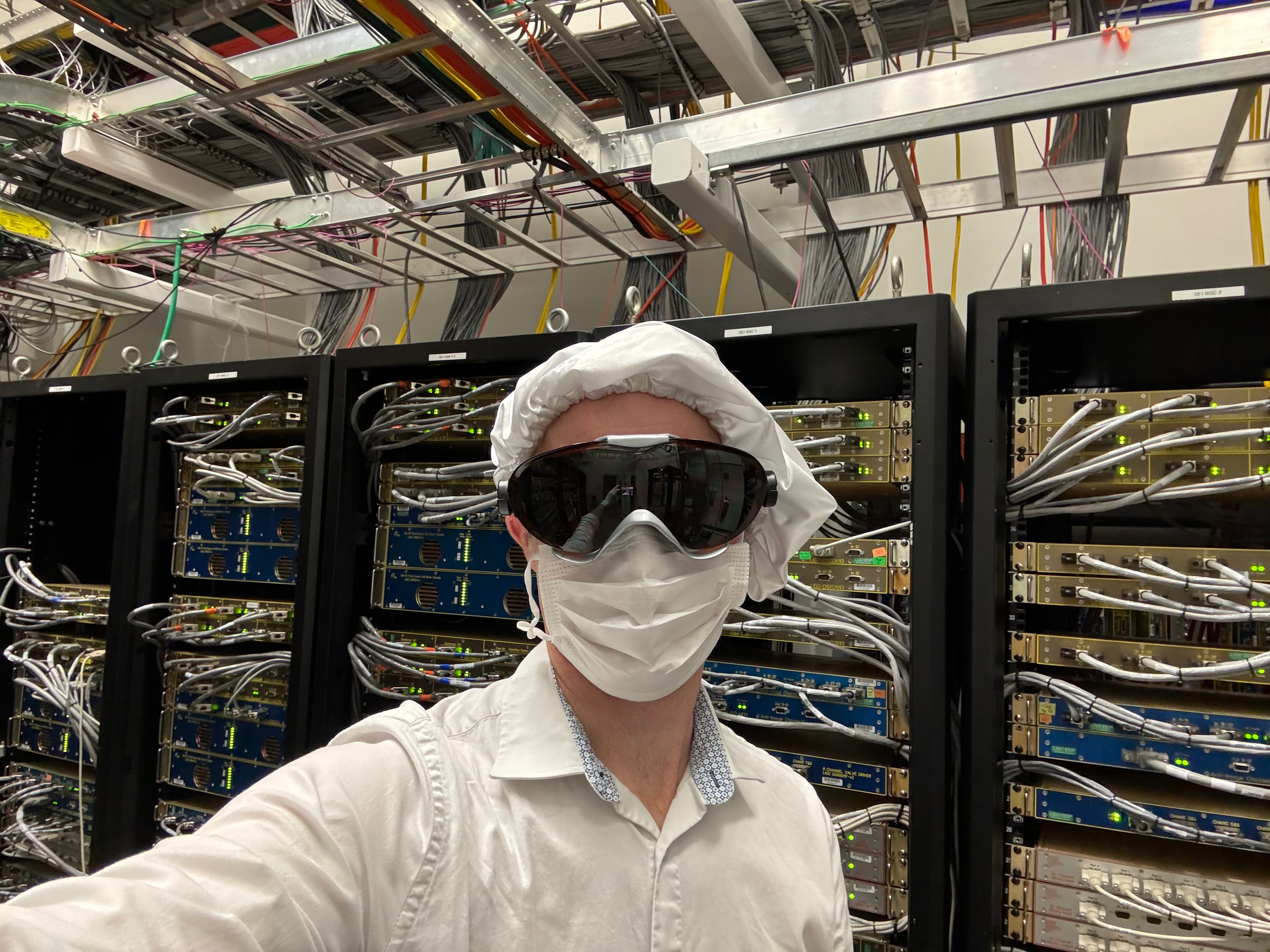 Checking cable installation in the electronics racks.