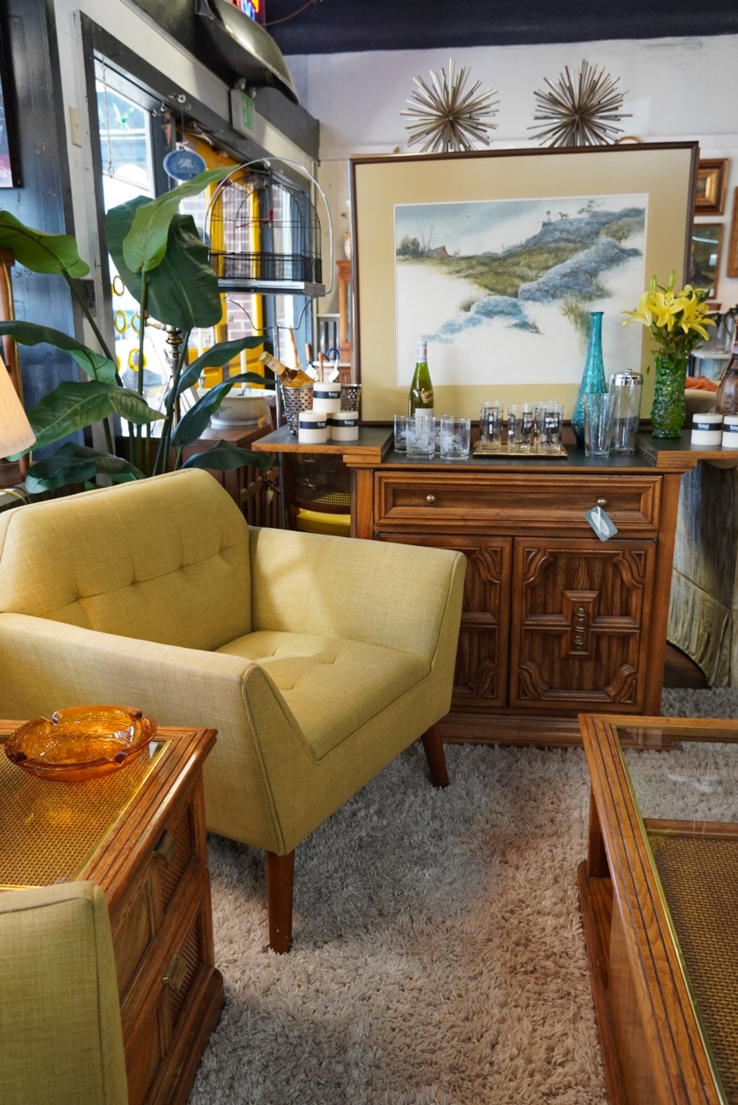 Pair of MCM butter yellow accent chairs, buffet and art.