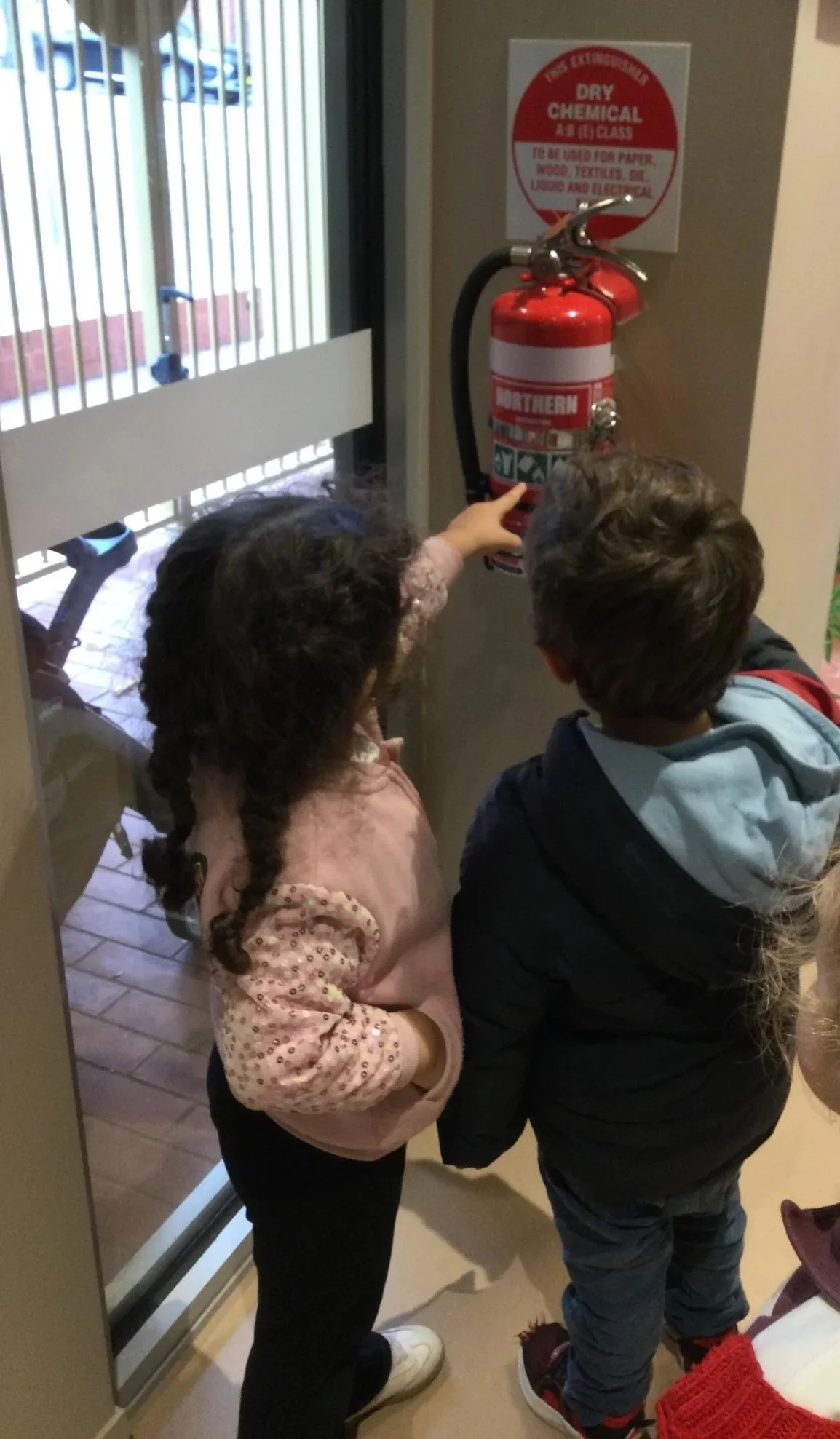 children learn about fire extinguisher at St Mary's Children Centre