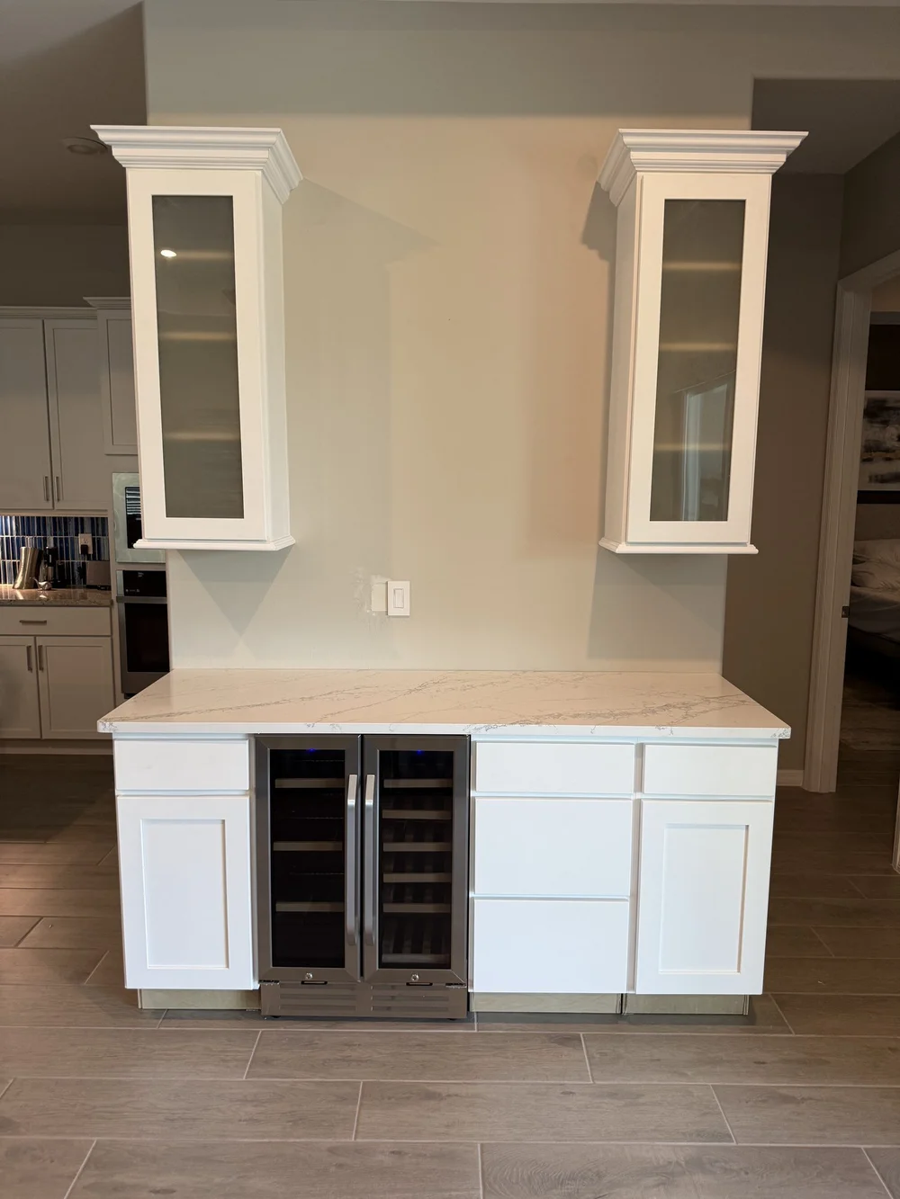 Countertop, wine fridge and upper cabinets installed before the backsplash