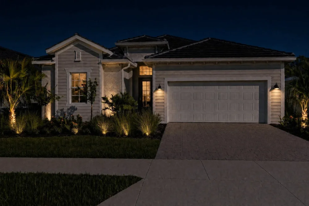 The same home at night with landscape lighting by Hideaway