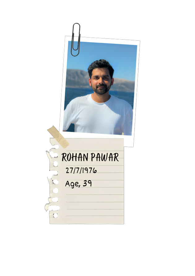 A photograph of a man with dark hair and a beard, wearing a white shirt, standing outdoors near water with mountains in the background. The photo is attached to a piece of lined paper with the name Rohan Pawar, birthdate 27/7/1976, and age 39 written on it, with a paperclip and tape decoration.