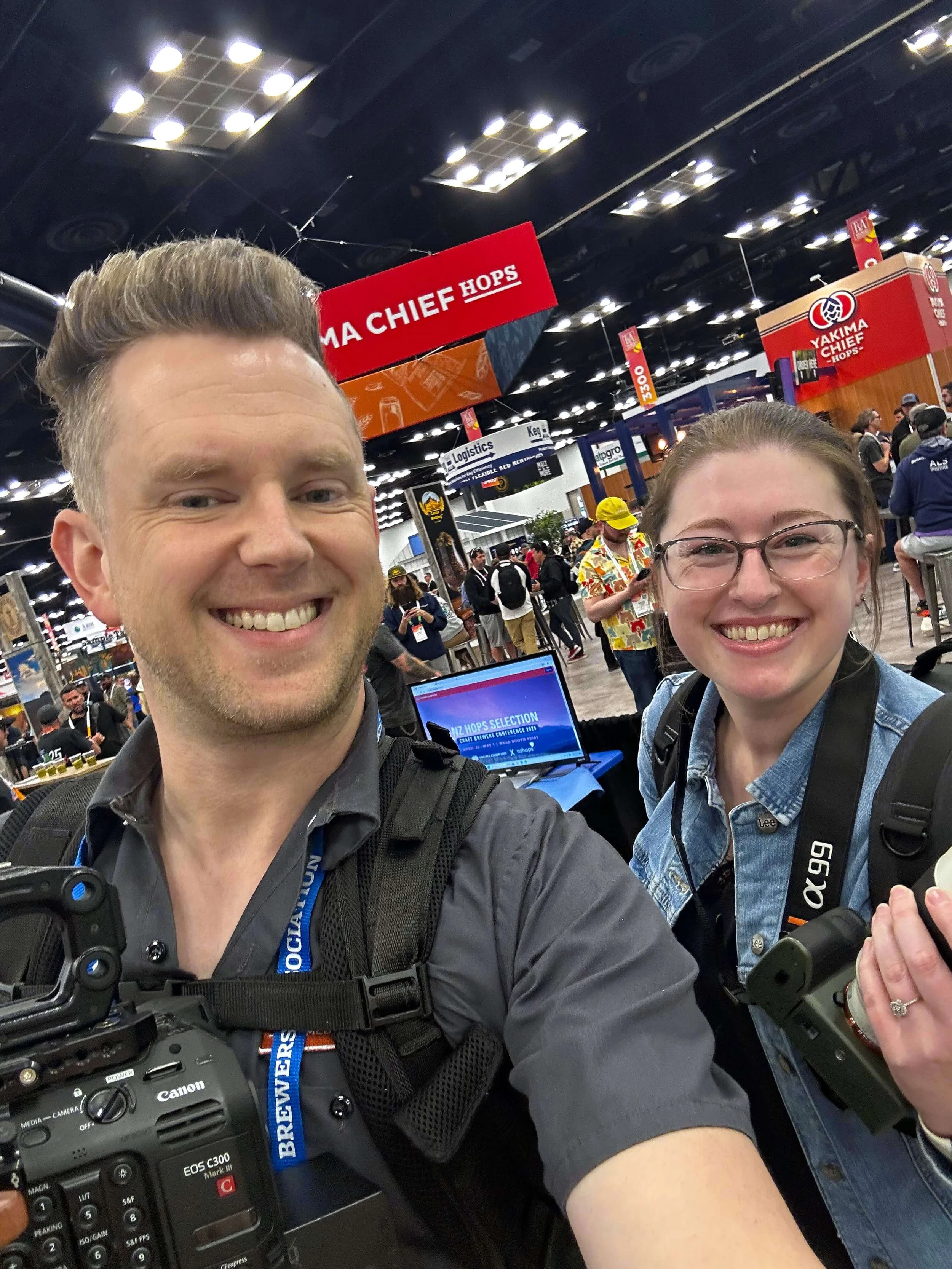 Event video production crew holding camera equipment and smiling