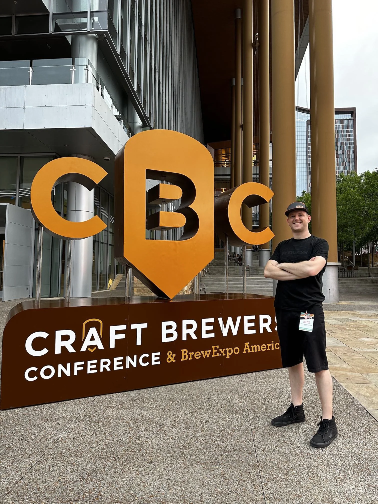 Video production crew standing in front of Craft Brewers Conference signage smiling