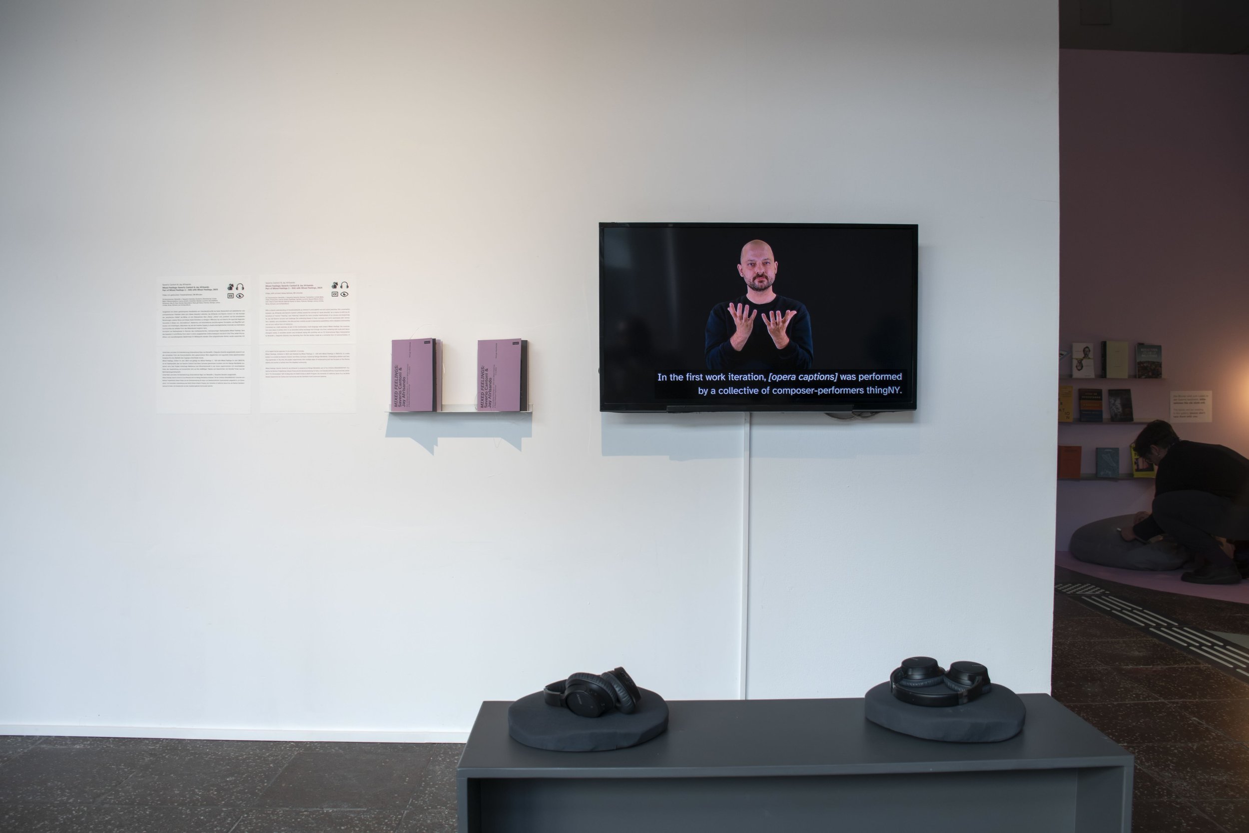 An installation of video featuring signed & captioned dialogue, and two printed transcriptions.