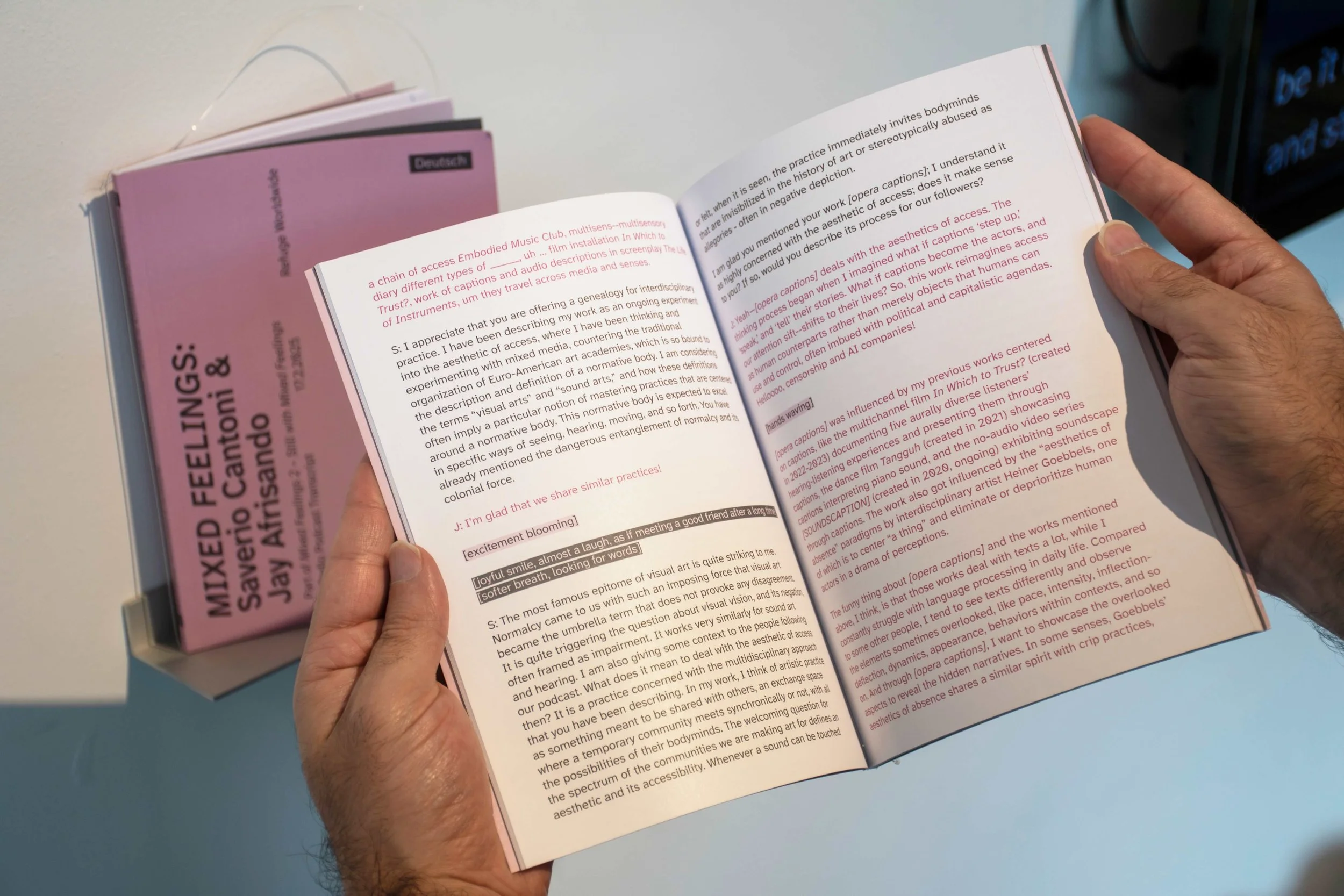 Hands opening one transcript book. Photo: Dani Hasrouni.