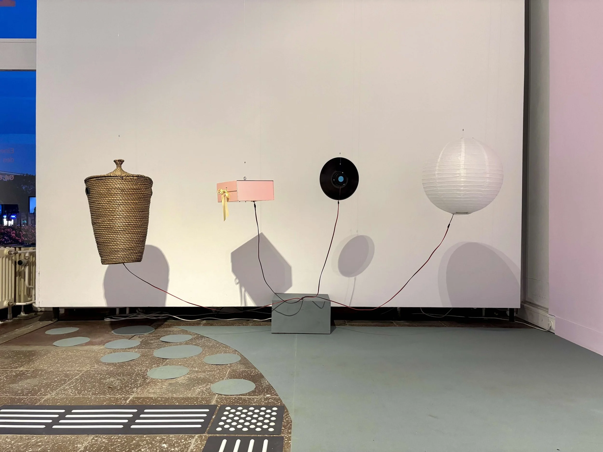 Jay and Morgan’s installation of vibrating objects to be touched, including a paper lantern, vinyl disc, gift box, and rattan basket. Photo: Jay Afrisando. Event: “In Conversation” exhibition, 2025.