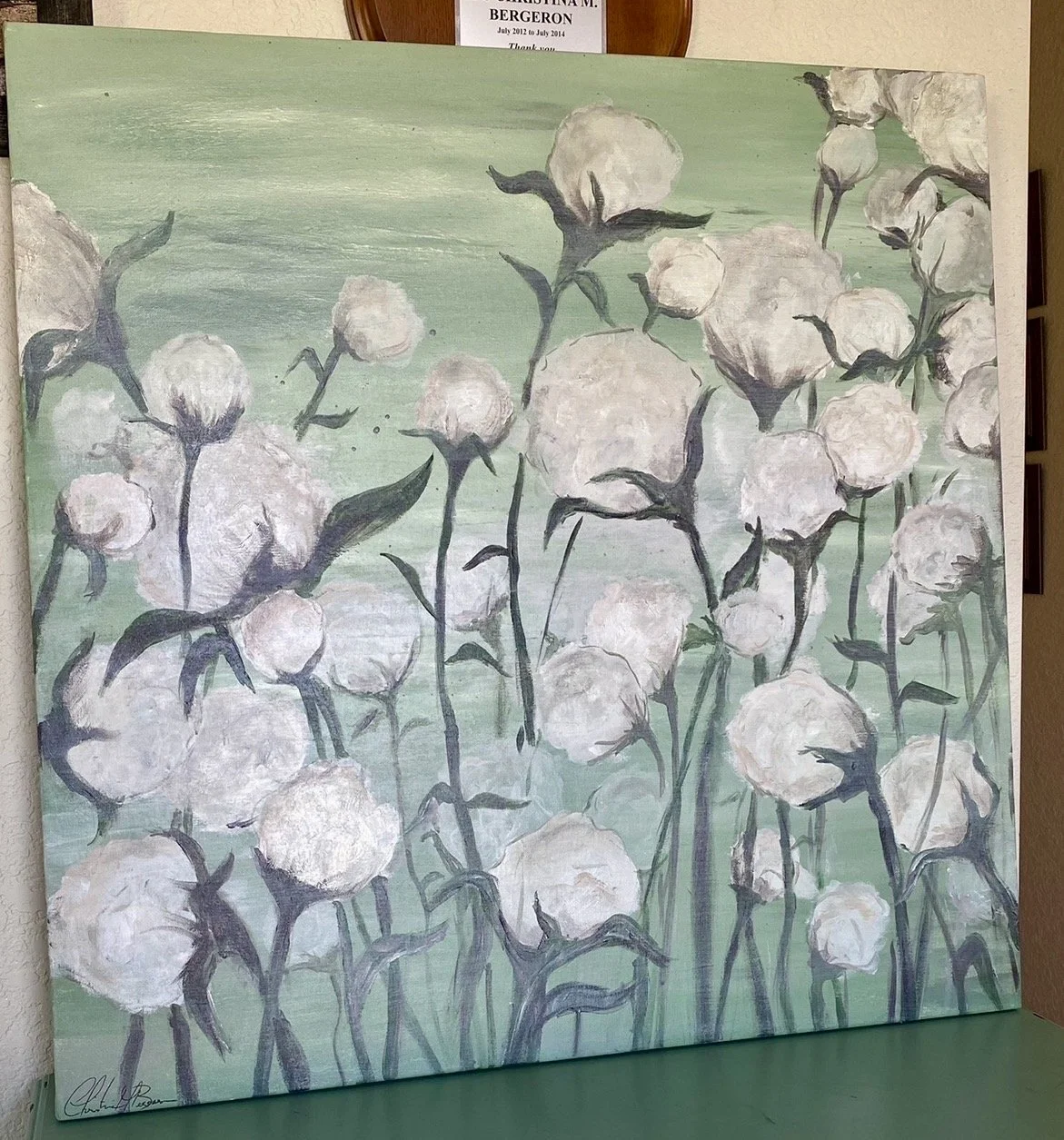 A painting of white cotton plants with dark stems and leaves against a green background.