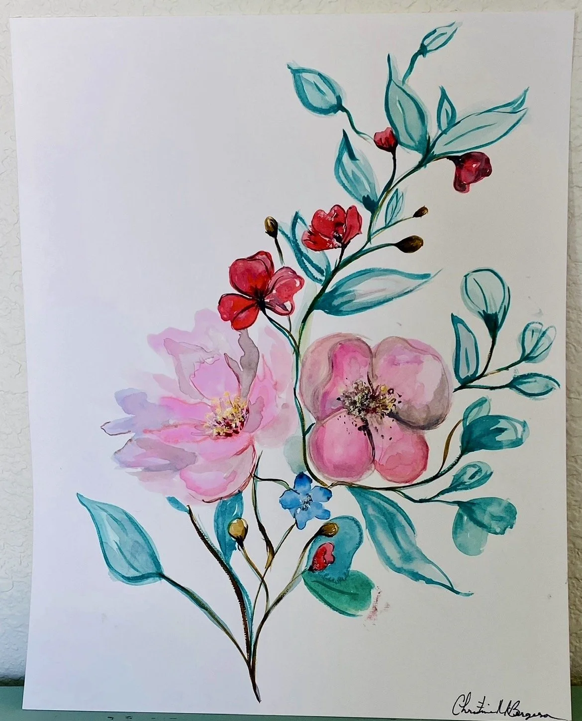 Watercolor painting of various pink, red, and blue flowers with green and blue leaves on a white background.