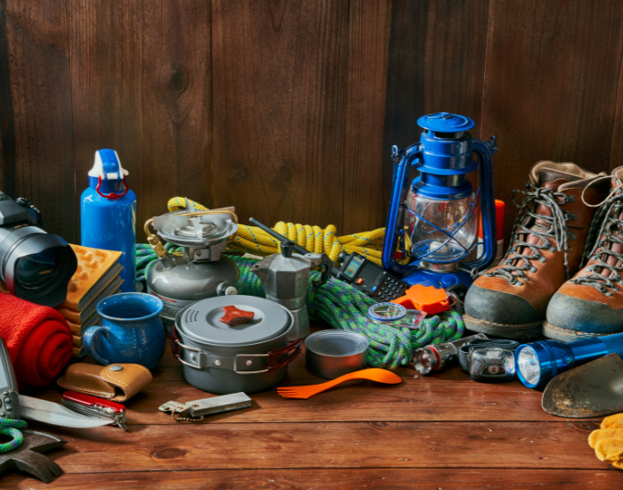 Getty Images adventure gear stacked together, including lamps, boots, cups