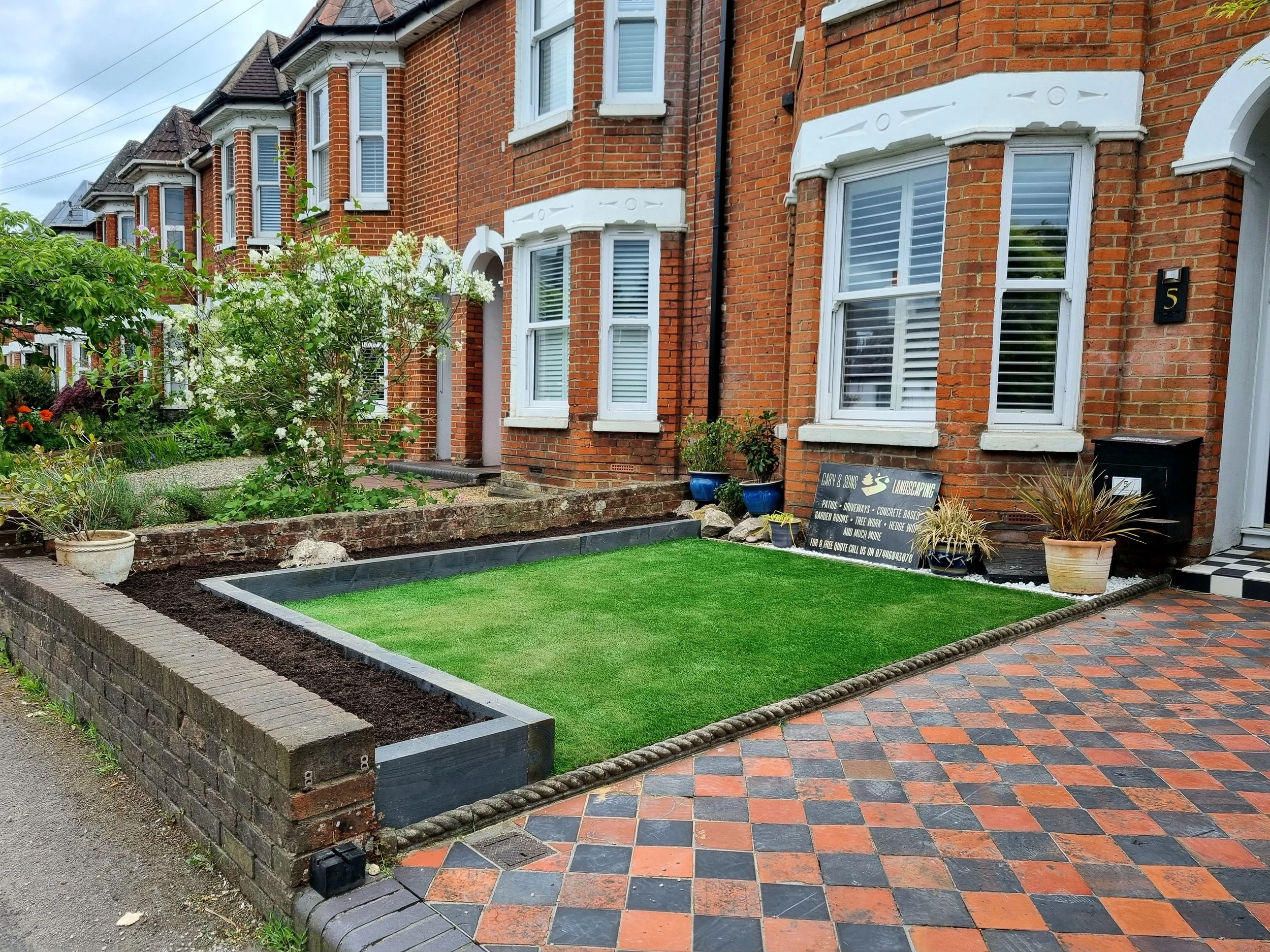 Front and back garden artificial grass installation, front planters built, front.