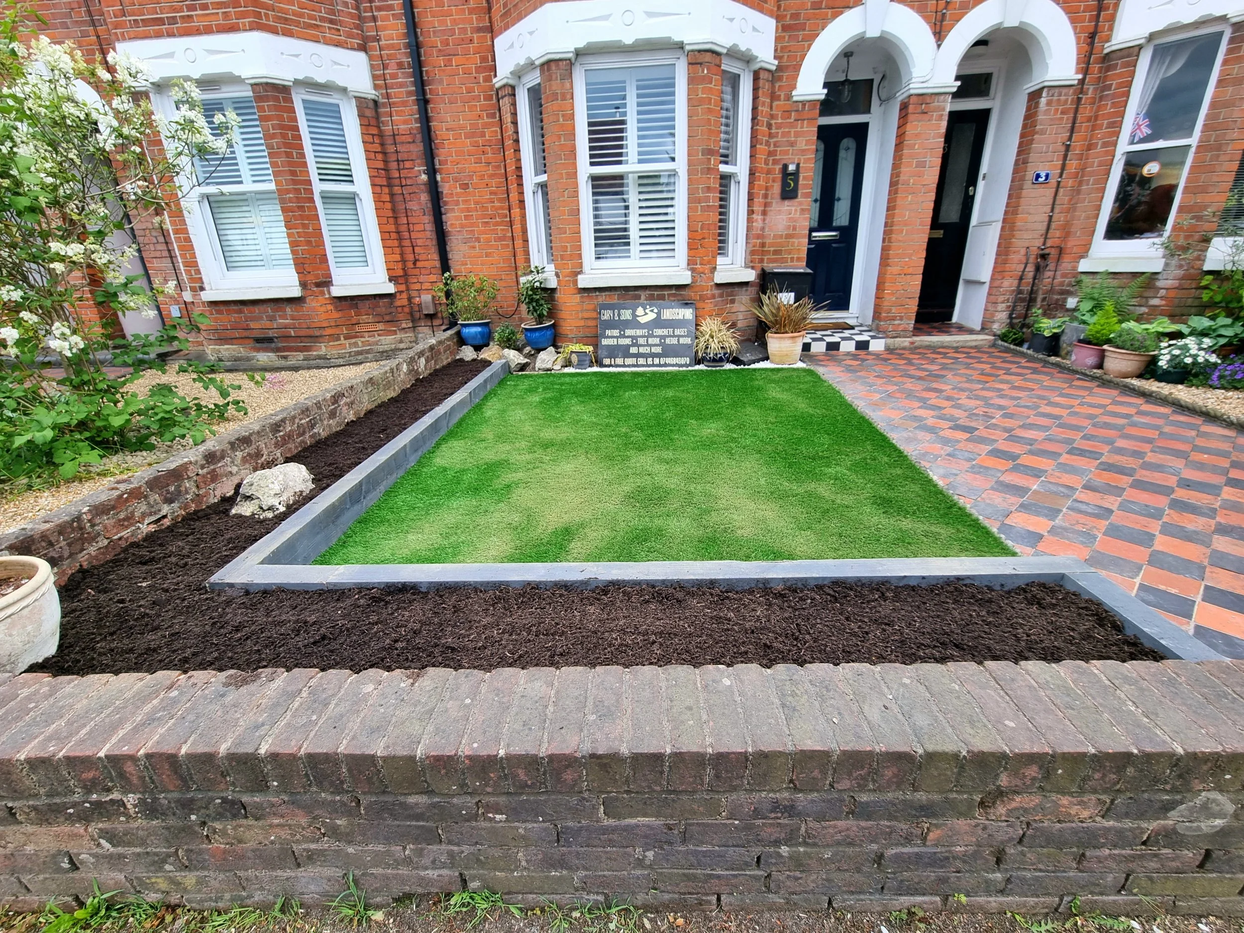Front and back garden artificial grass installation, front planters built, front.