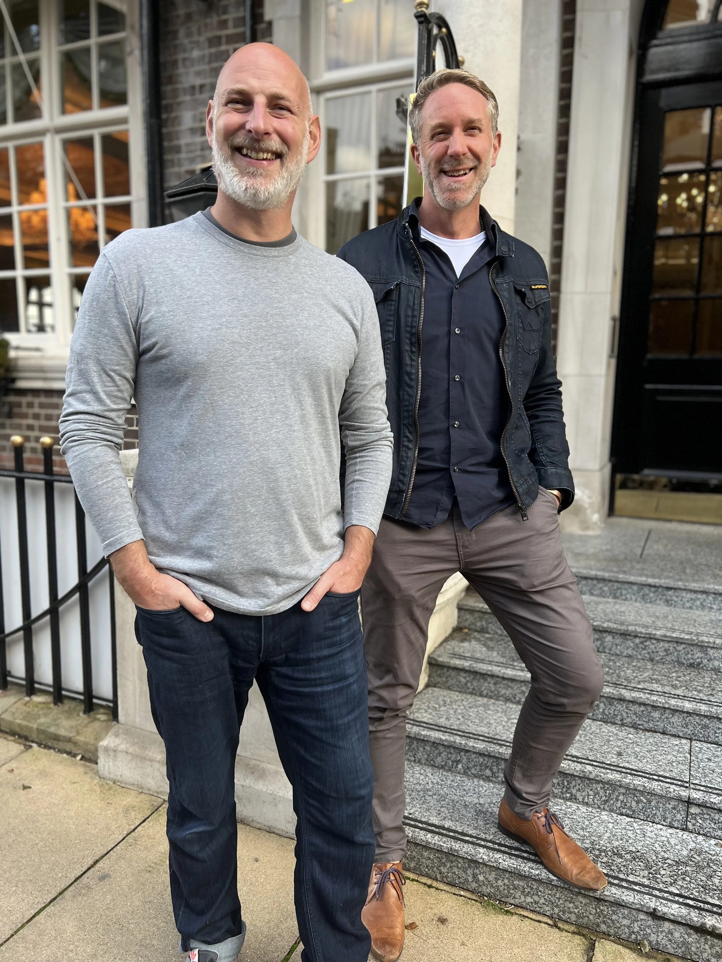 Tim Beames and Karl Monahan, co-founders of Pelvic Pain Matters, standing together and smiling, representing their partnership in supporting men with chronic pelvic pain recovery