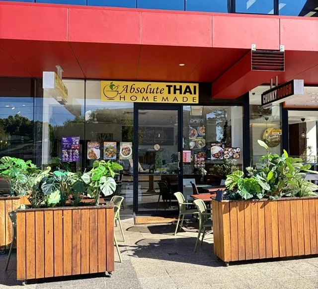 Thai restaurant in Southport Central showing the outside seating area and foliage on a bright sunny day.