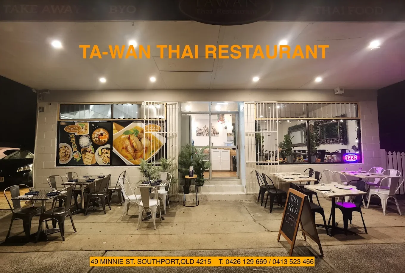 Exterior of TA-WAN Thai Restaurant with outdoor seating and a sign indicating the restaurant is open, located at 49 Minnie St, Southport, QLD, with contact numbers