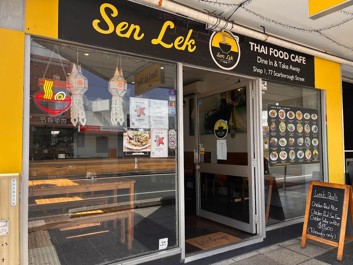 Thai food cafe named Sen Lek with takeout and dine-in options, located at 77 Scarborough Street. The storefront features a black and yellow color scheme, a menu display, and a chalkboard with lunch specials.