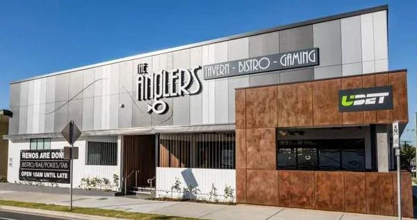 Exterior of The Ambers tavern, bistro, and gaming establishment with a white and brown facade, and a sign for UBET on the right side.