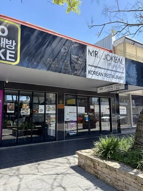 Outside view of Korean restaurant 'Mr Jokbal' in Southport showing front awning, signage and windows.