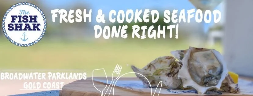 Banner for The Fish Shak restaurant featuring fresh and cooked seafood, with a logo and a shellfish dish on a wooden surface.