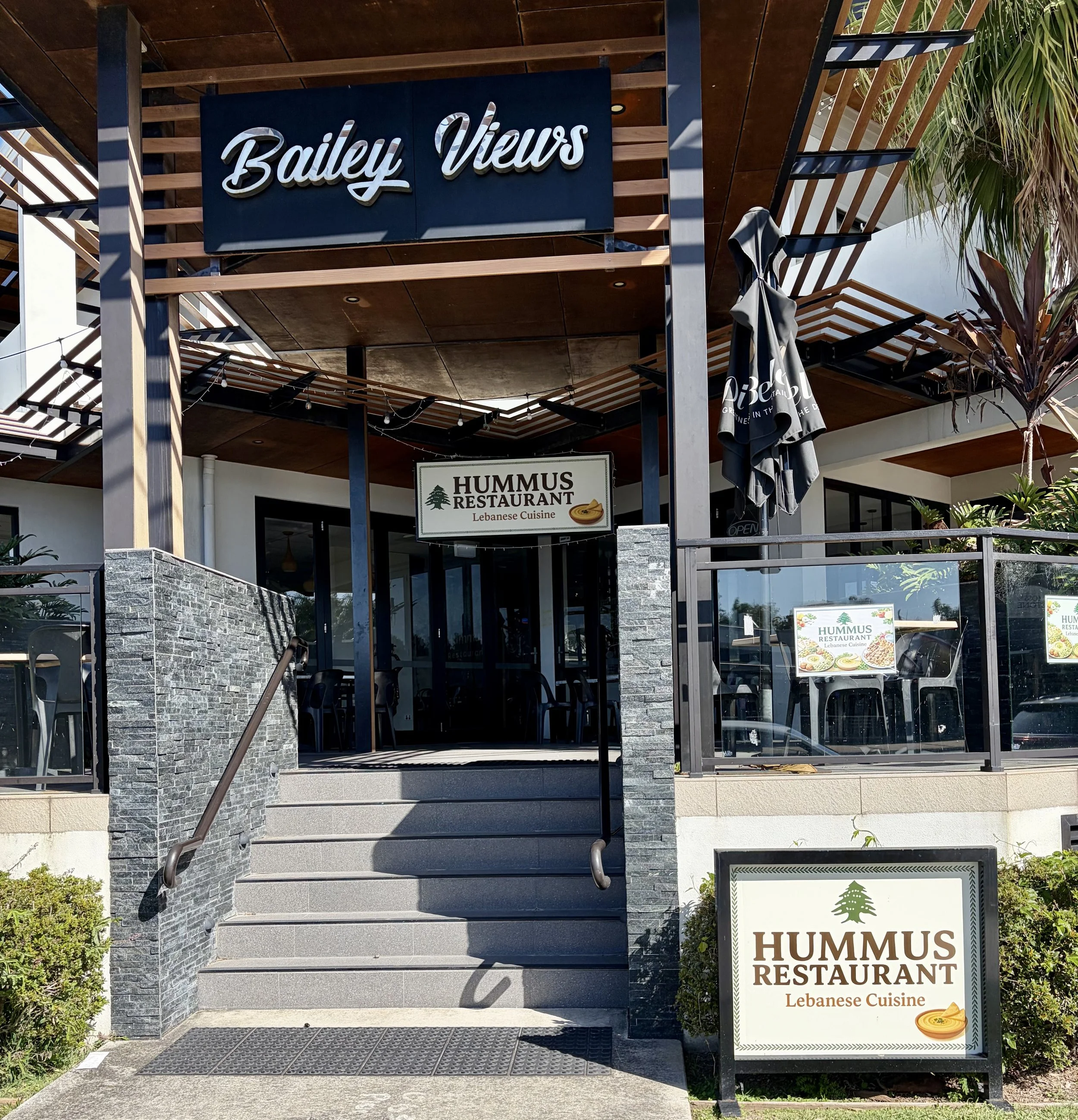 Entry and outside seating area for Lebanese restaurant Hummus
